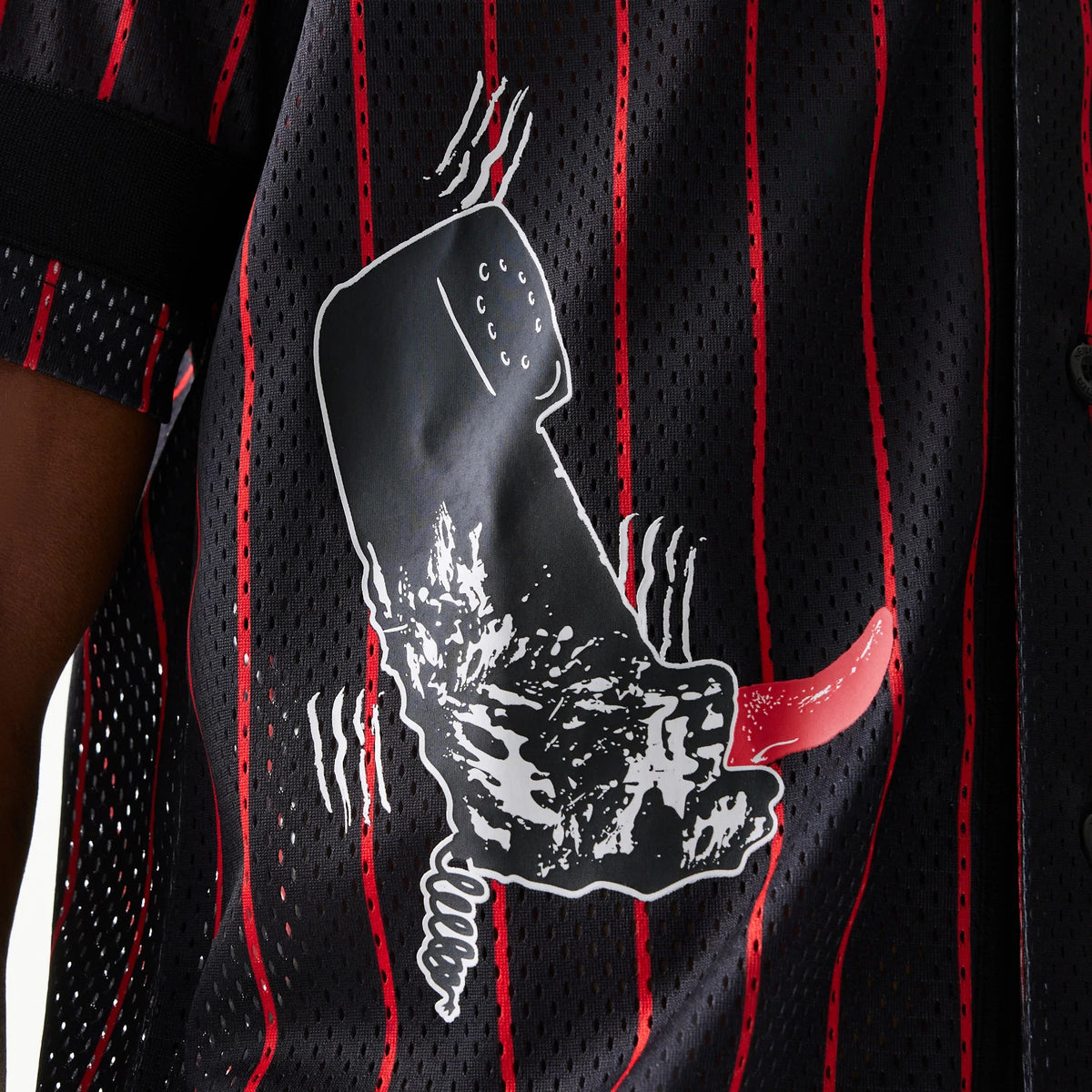 New Era A Nightmare On Elm Street Black Jersey, side view showing the detailed print of Freddy Krueger's glove on a black fabric with vertical red stripes, creating a and eerie effect.