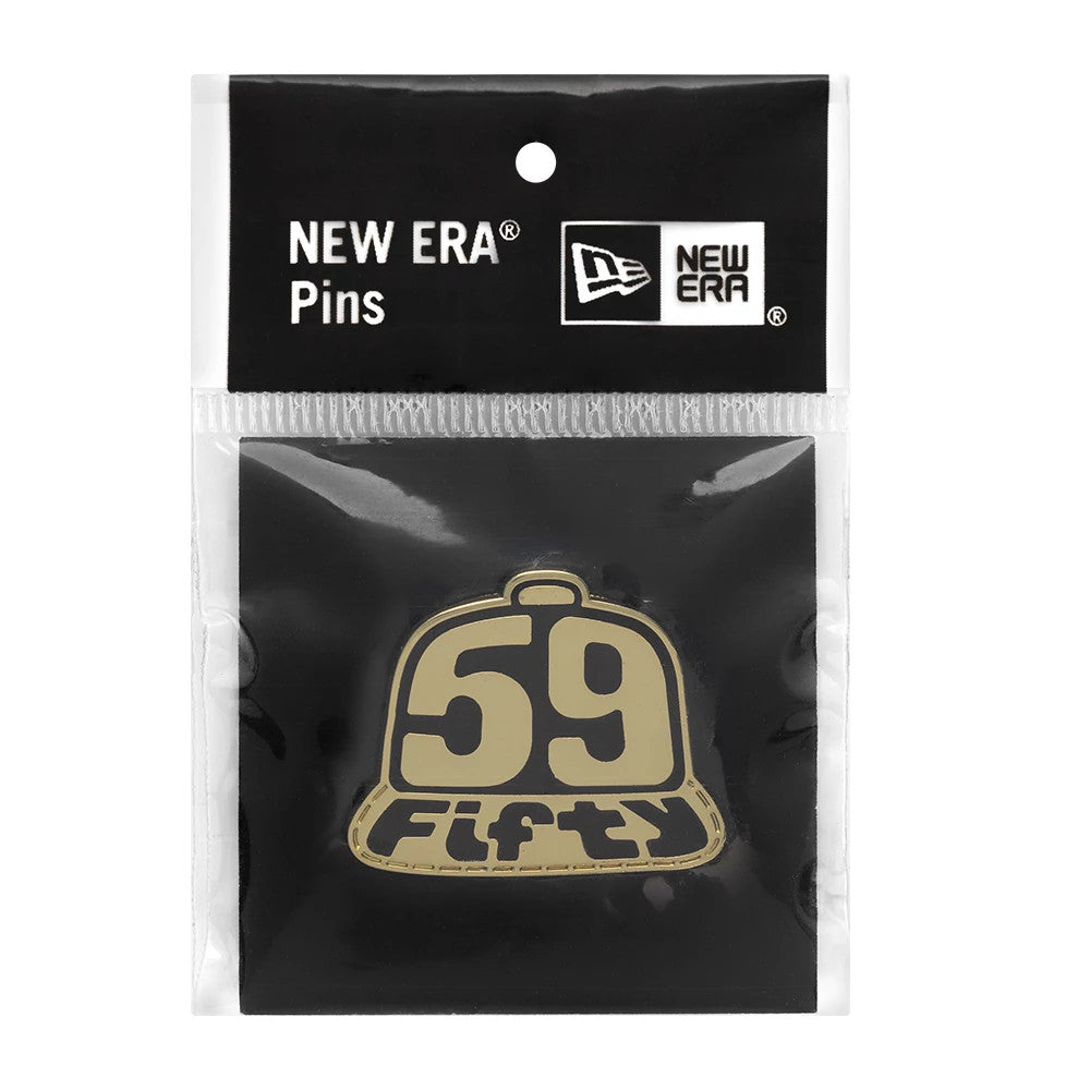 New Era 59FIFTY Day Cap Gold Pin Badge, front view showing a gold cap-shaped pin with 59 Fifty in black numbers and letters, packaged in a clear wrapper with a black top header featuring the New Era logo and Pins label.