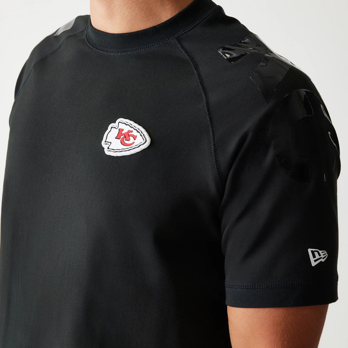 New Era Kansas City Chiefs NFL 3RD Down Black T-Shirt, front view showing the raised Chiefs logo on the left chest, glossy black details on the shoulder, and the embroidered New Era logo on the left sleeve.