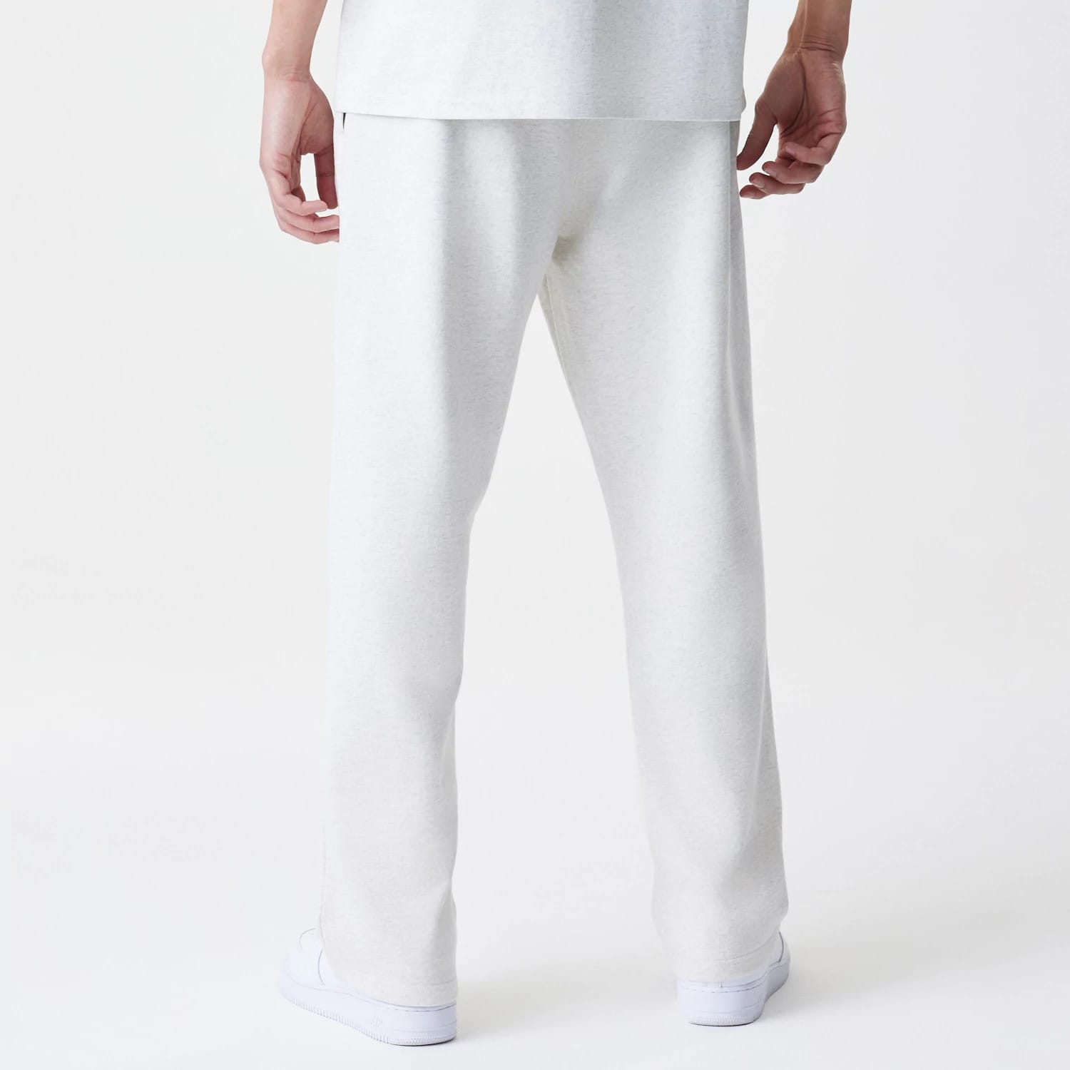 The Male model is wearing New Era Premium Essential Pastel Grey Joggers 2