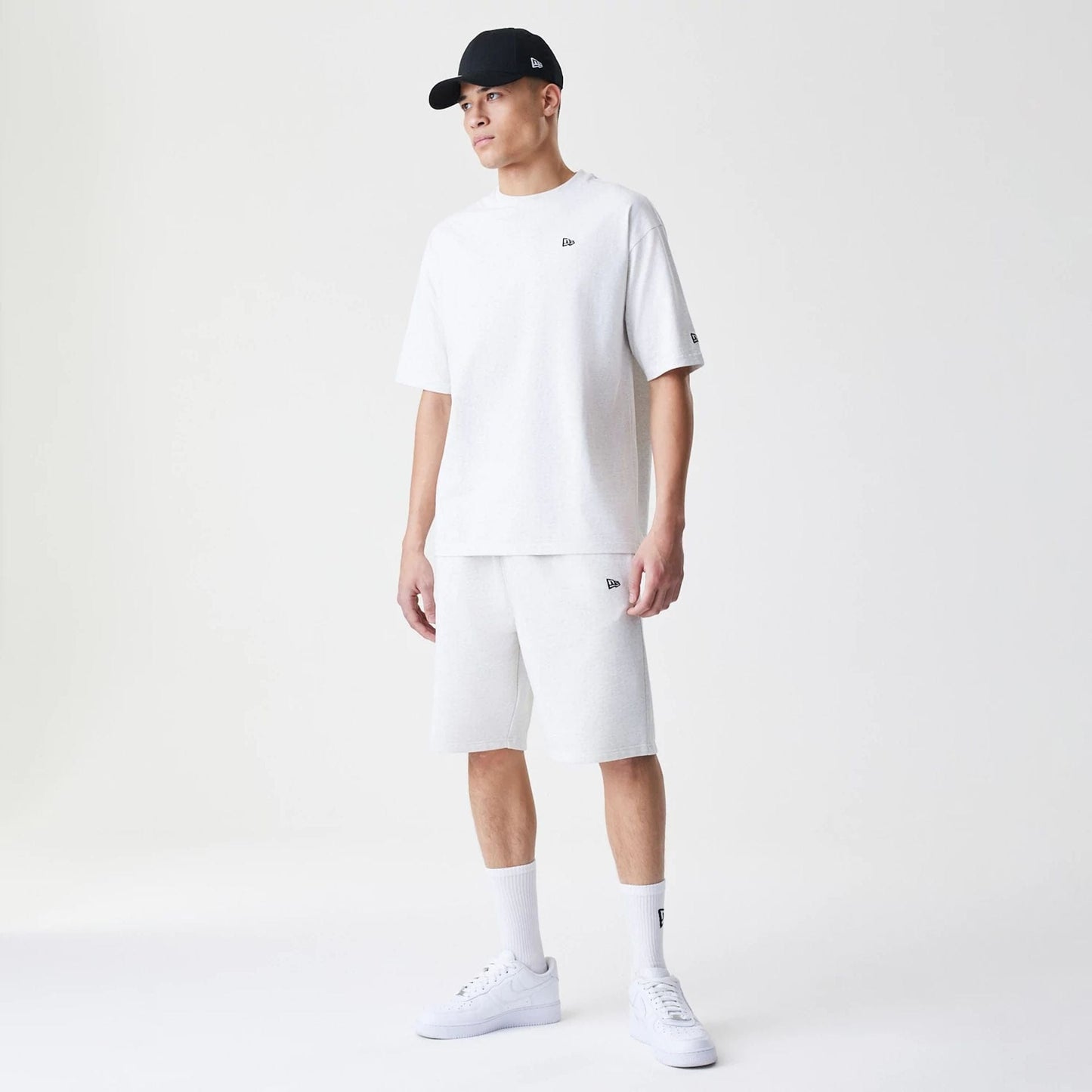 The Male model is wearing New Era Premium Essential Pastel Grey Oversized T-Shirt 8