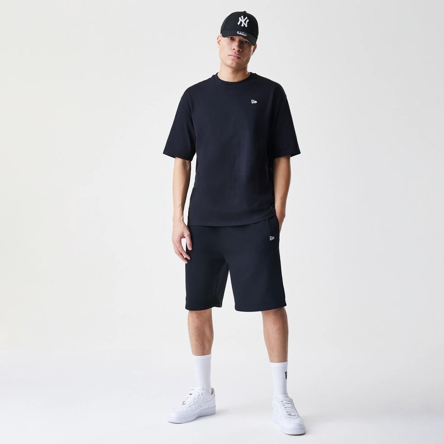 The Male model is wearing New Era Premium Essential Black Oversized T-Shirt 8