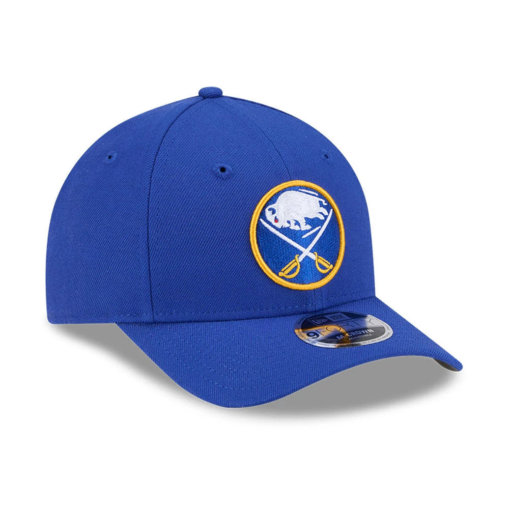 Buffalo Sabres NHL Team Blue New Era 9FORTY M-Crown Adjustable Cap, three-quarter view showing the raised embroidered Sabres logo on the structured blue crown with a curved blue visor and a 9FORTY size sticker.