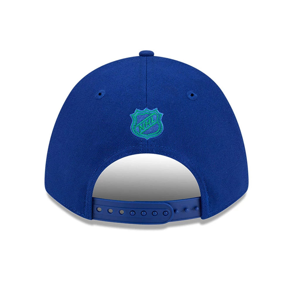Vancouver Canucks NHL Team Blue New Era 9FORTY M-Crown Adjustable Cap, rear view showing the green embroidered NHL-shaped team logo at the centre of the back panels, with a blue adjustable strap below.