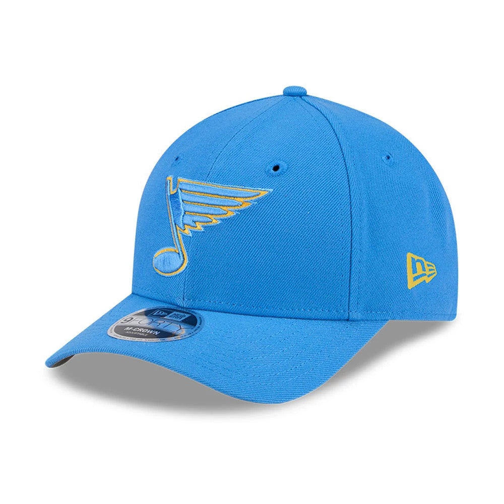 St. Louis Blues NHL Team Blue New Era 9FORTY M-Crown Adjustable Cap, three-quarter view showing the yellow embroidered logo on the curved blue visor and a 9FORTY size sticker, with the New Era flag logo on the left side.