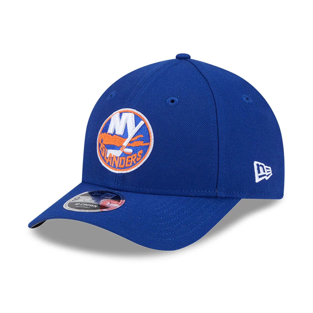 New York Islanders NHL Team Blue New Era 9FORTY M-Crown Adjustable Cap, three-quarter view showing the raised embroidered team logo on the front panel, curved blue visor with 9FORTY size sticker, and New Era flag logo on the left side.