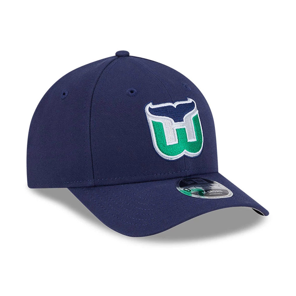 Hartford Whalers NHL Team Navy New Era 9FORTY M-Crown Adjustable Cap, front view showing the raised embroidered team logo in green and white on the navy front panel, with a curved visor and 9FORTY size sticker.
