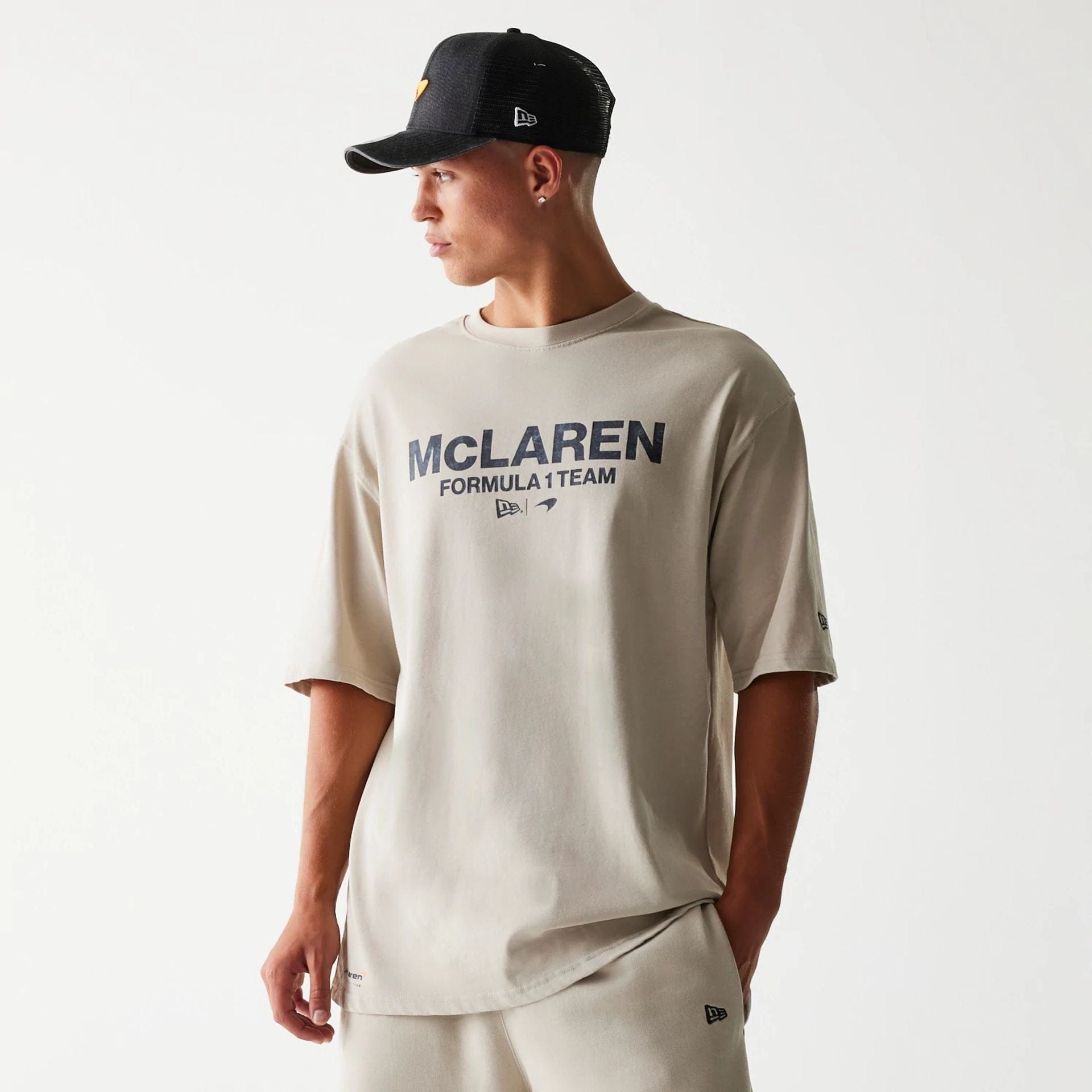 The Male model is wearing McLaren Racing Wordmark Light Beige Oversized T-Shirt 1