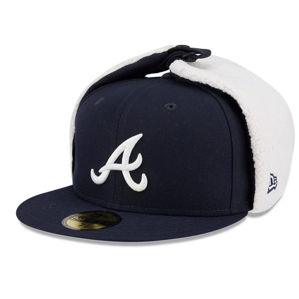 Atlanta Braves MLB Classic Navy New Era 59FIFTY Fitted Cap, three-quarter view showing a raised white A logo on the navy front panel, navy flat visor, and a gold 59FIFTY size sticker, with white fleece-lined dogear flaps on the sides.