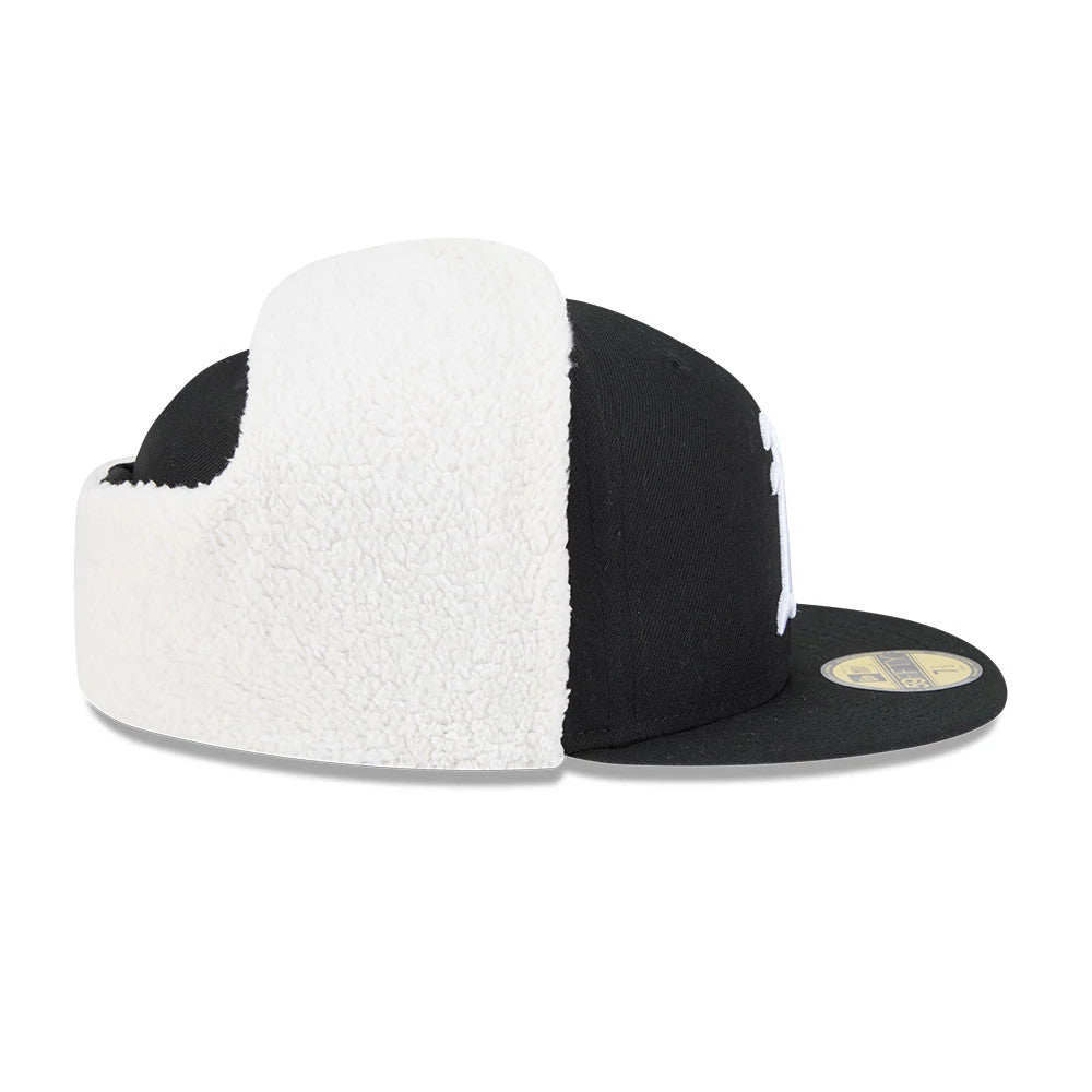 Athletics MLB Classic Black Dogear New Era 59FIFTY Fitted Cap, side view with white fluffy dogears folded up, showcasing the structured black crown, curved black visor, and gold 59FIFTY size sticker on the visor.