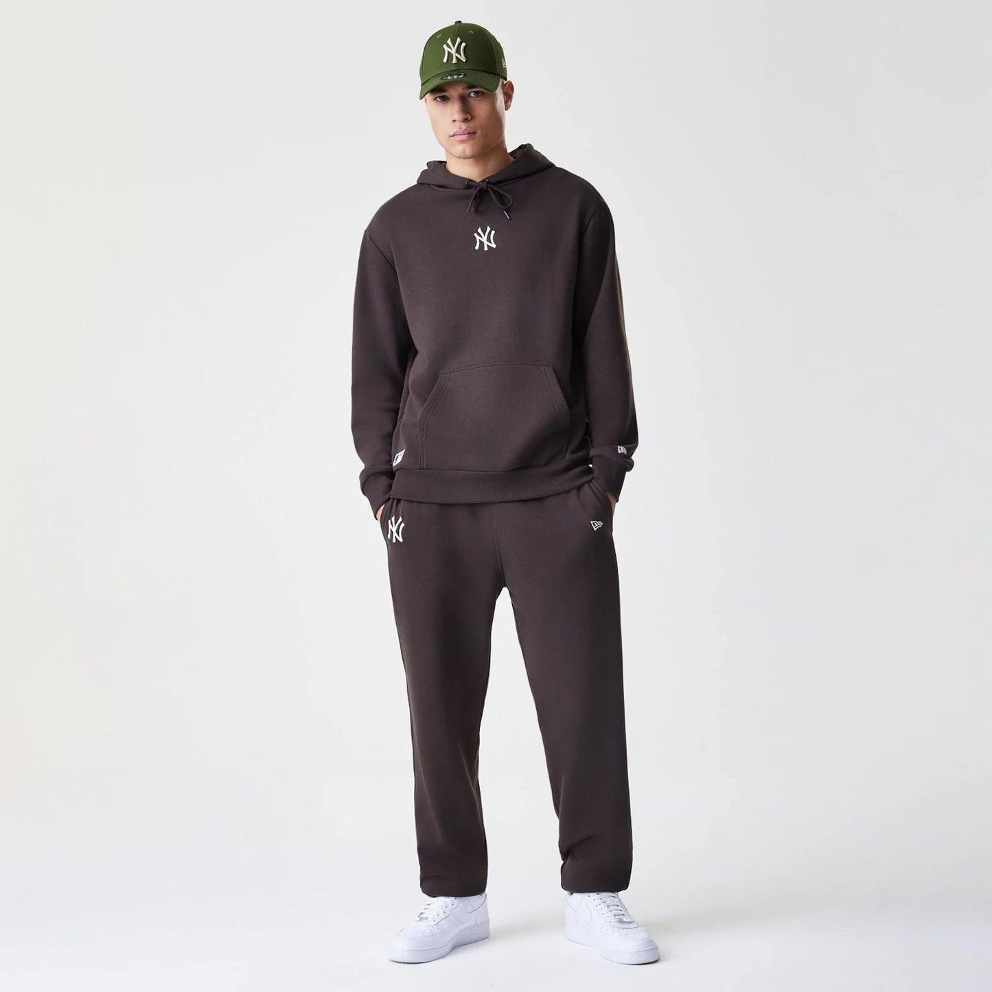The Male model is wearing New York Yankees MLB Midi League Essential Dark Brown Oversized Pullover Hoodie 5