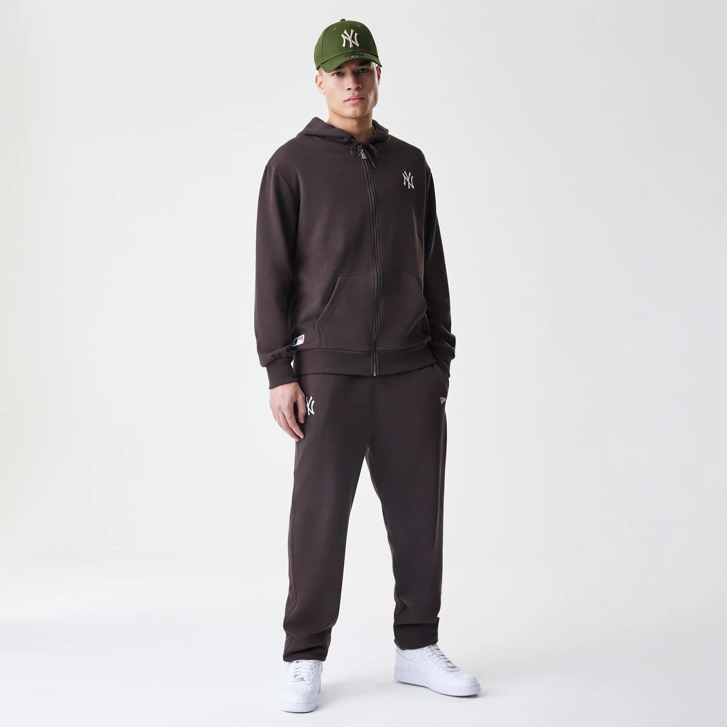 The Male model is wearing New York Yankees MLB Midi League Essential Dark Brown Full Zip Hoodie 8