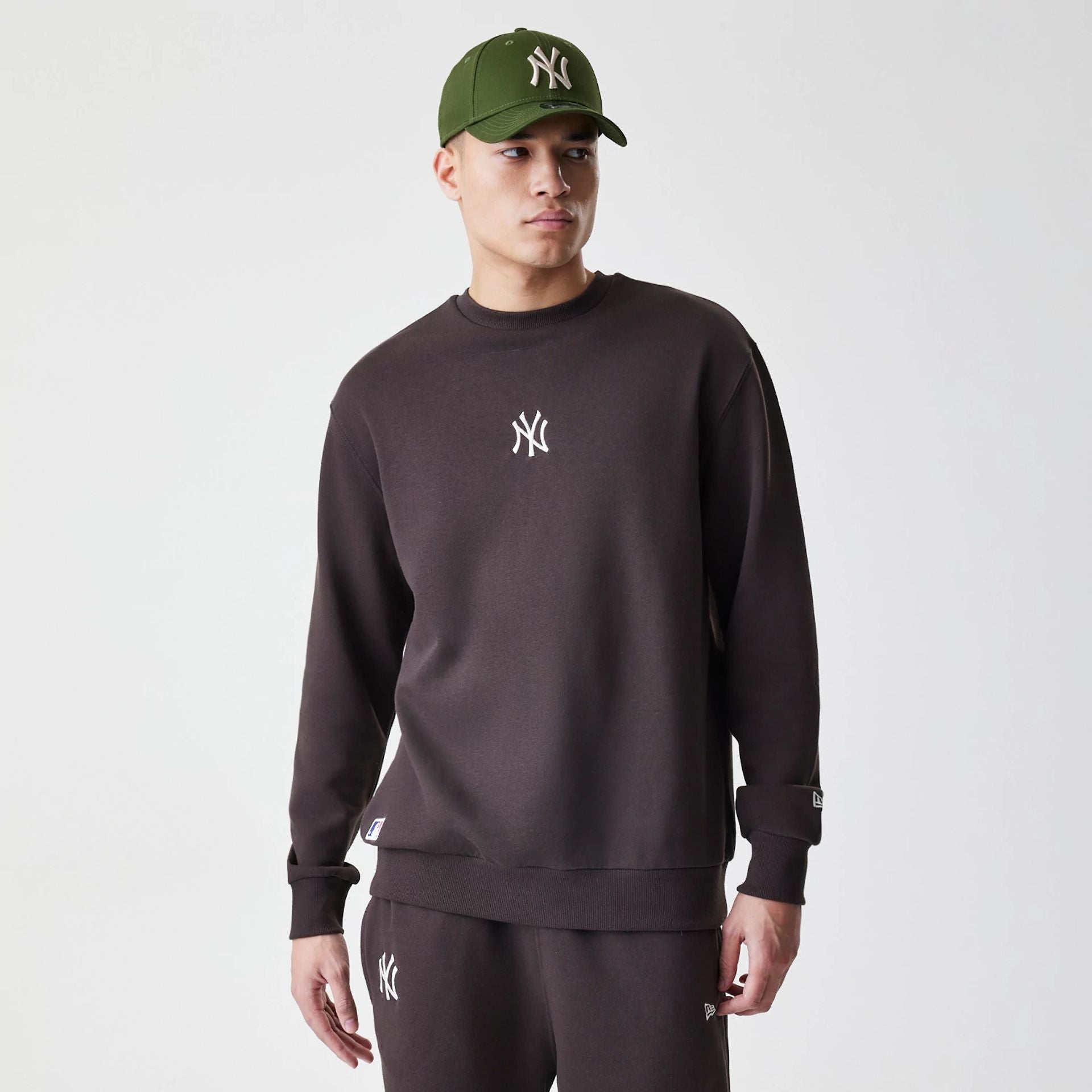 The Male model is wearing New York Yankees MLB Midi League Essential Dark Brown Oversized Crew Neck Sweater 1