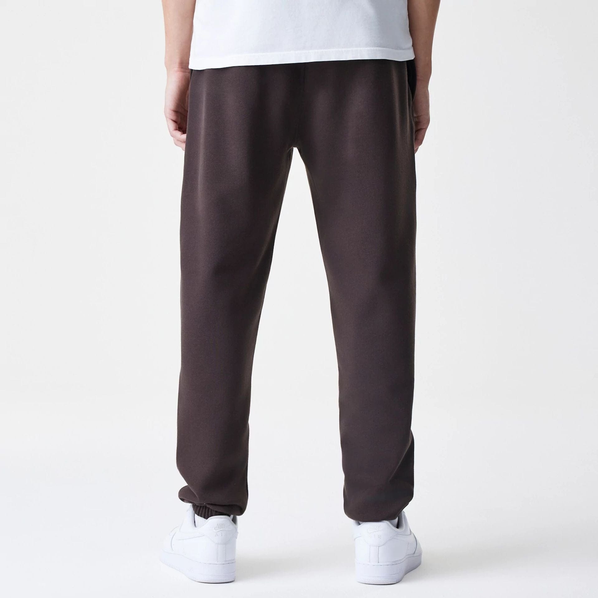 The Male model is wearing New York Yankees MLB Midi League Essential Dark Brown Joggers 2