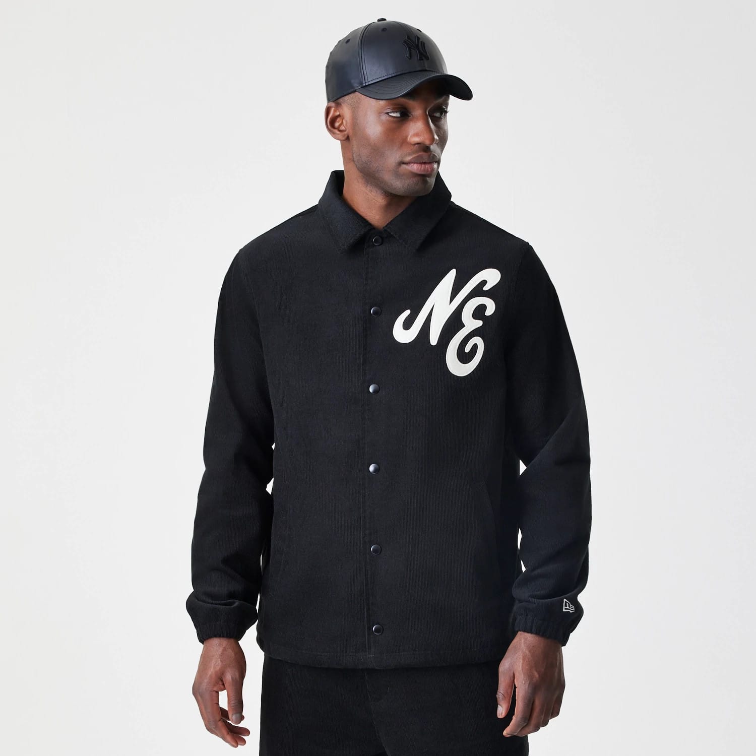 The Male model is wearing New Era Cord Black Coaches Jacket 3