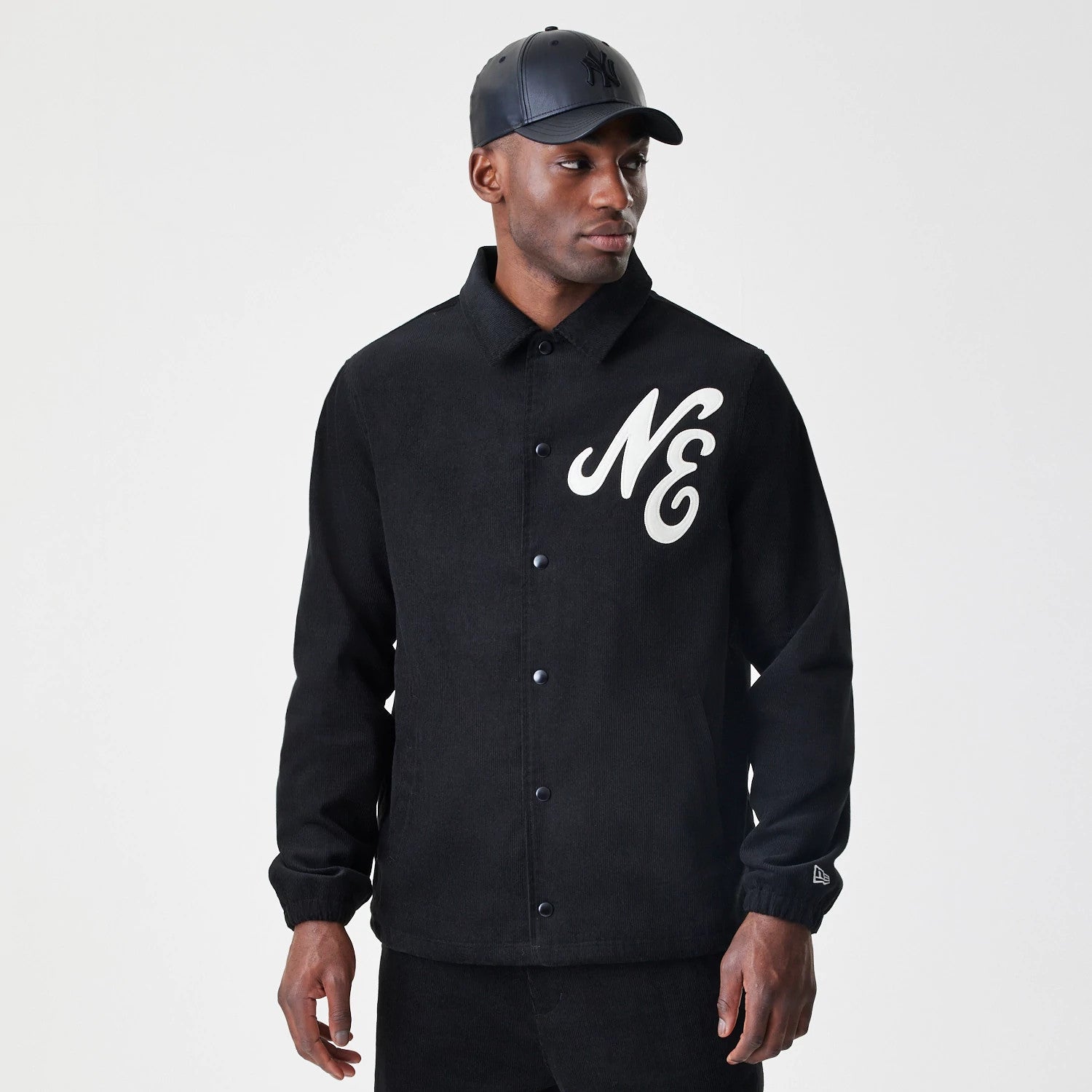 The Male model is wearing New Era Cord Black Coaches Jacket 3