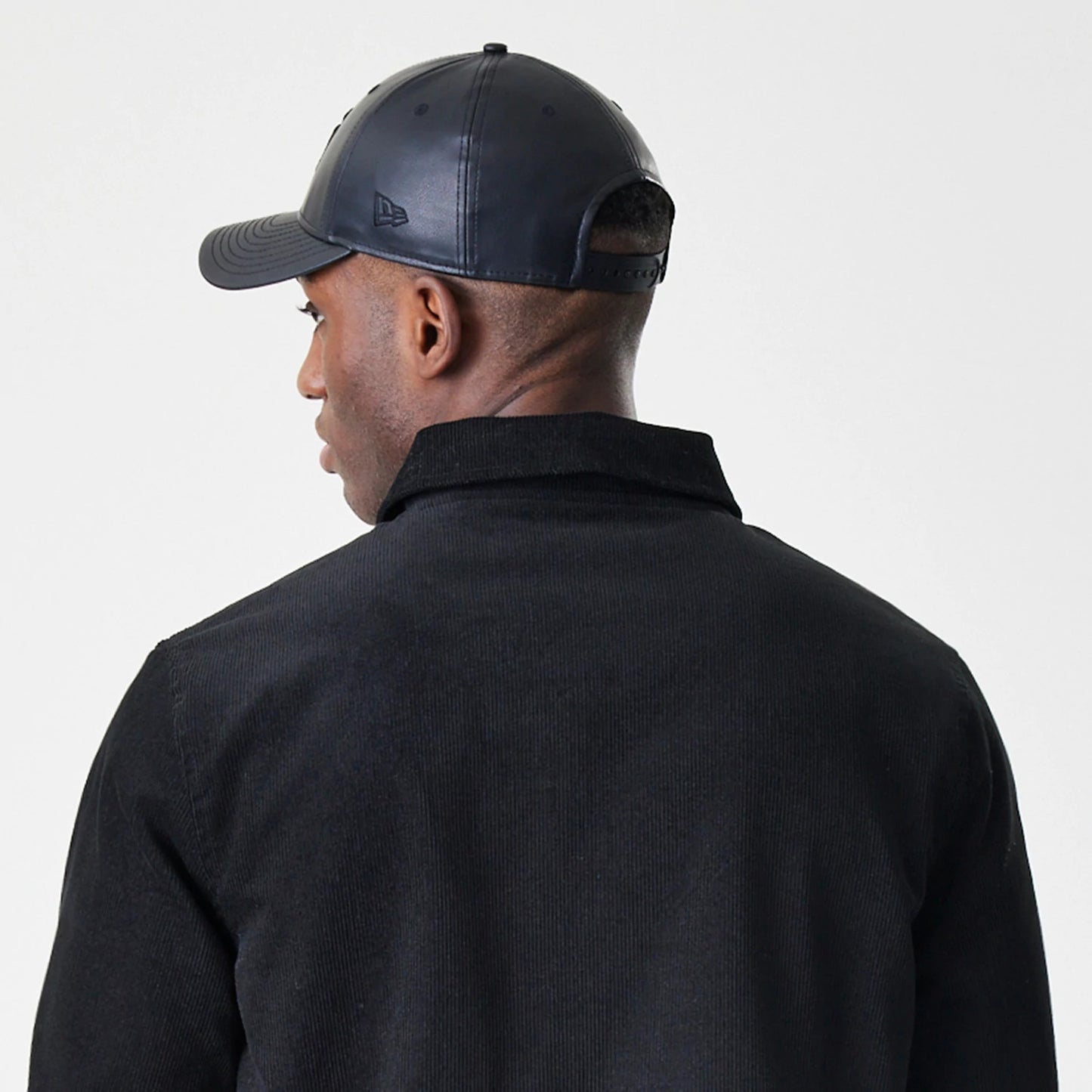 The Male model is wearing New Era Cord Black Coaches Jacket 8