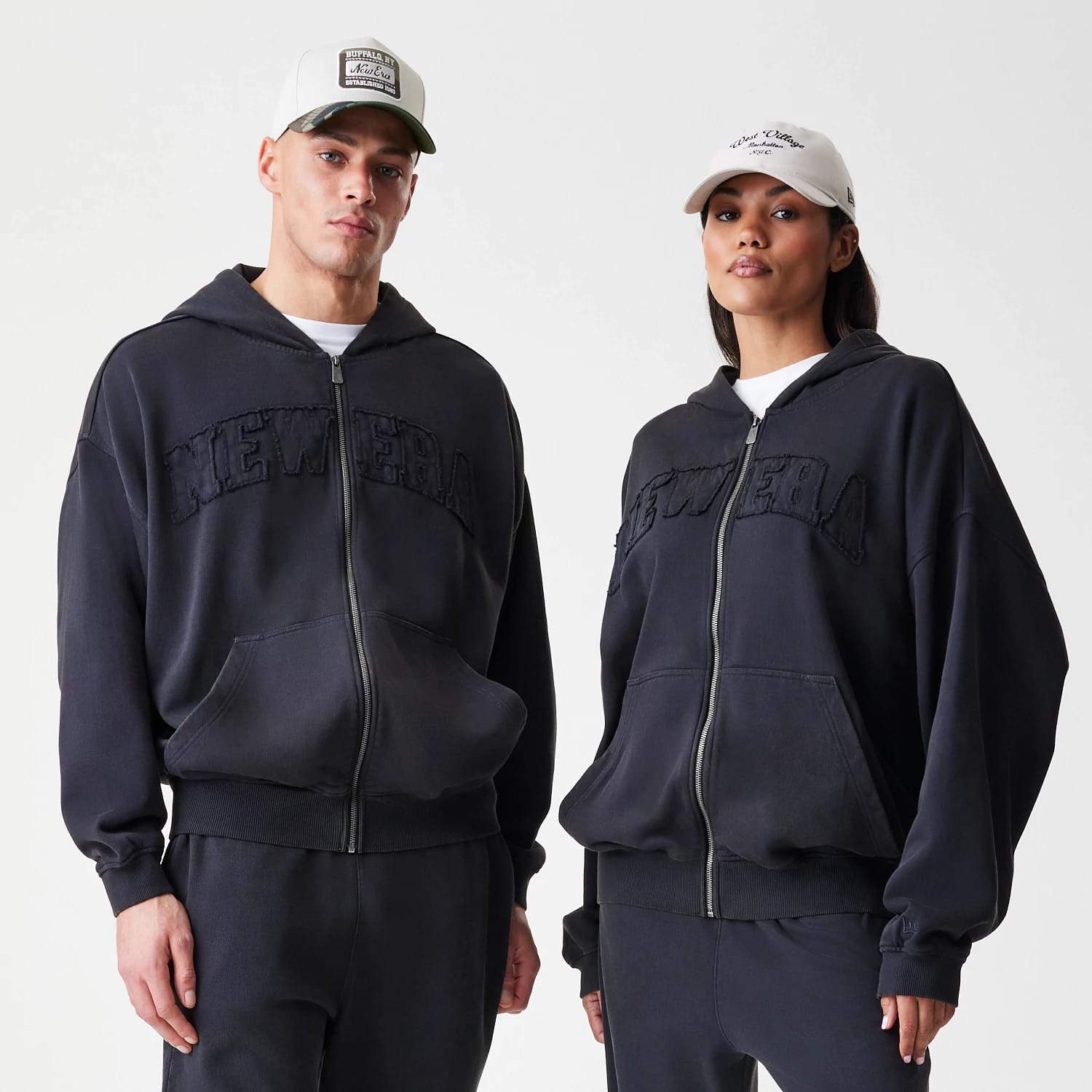 The Male model is wearing New Era Washed Black Oversized Full Zip Hoodie 1