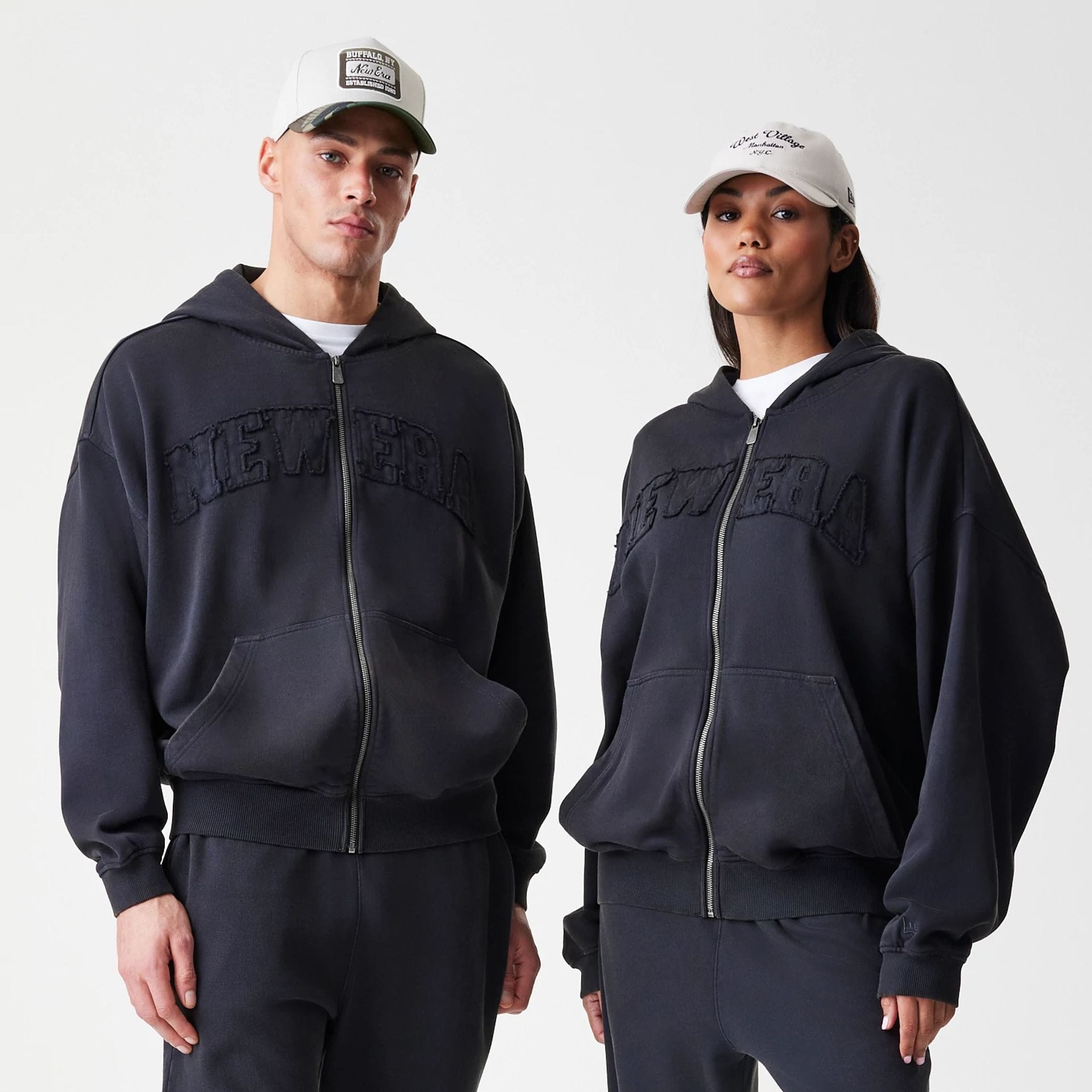 The Male model is wearing New Era Washed Black Oversized Full Zip Hoodie 1