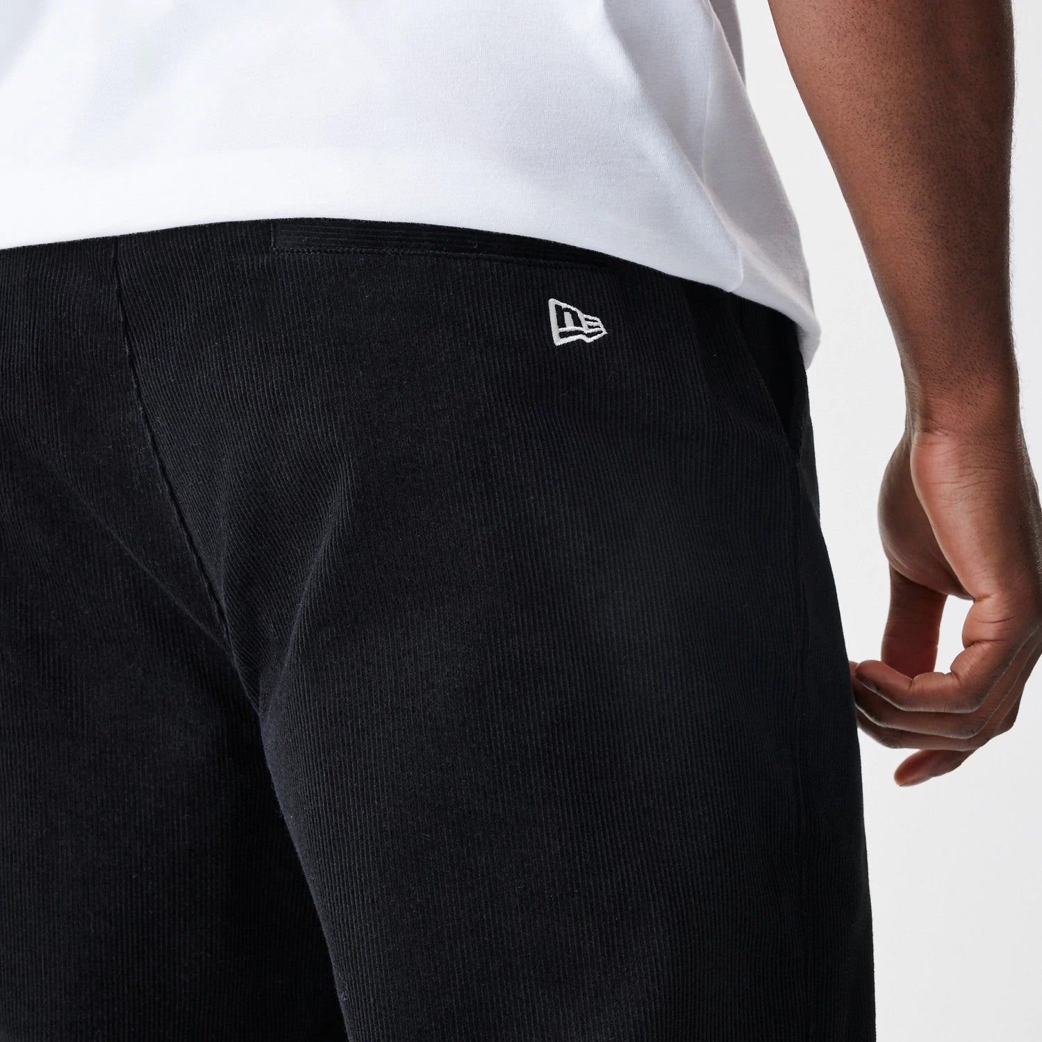 The Male model is wearing New Era Cord Black Straight Leg Chinos 4