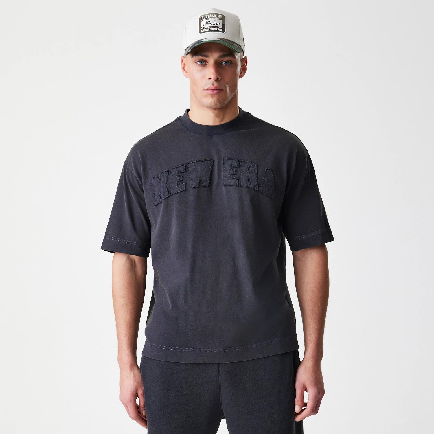 The Male model is wearing New Era Washed Black Oversized T-Shirt 3