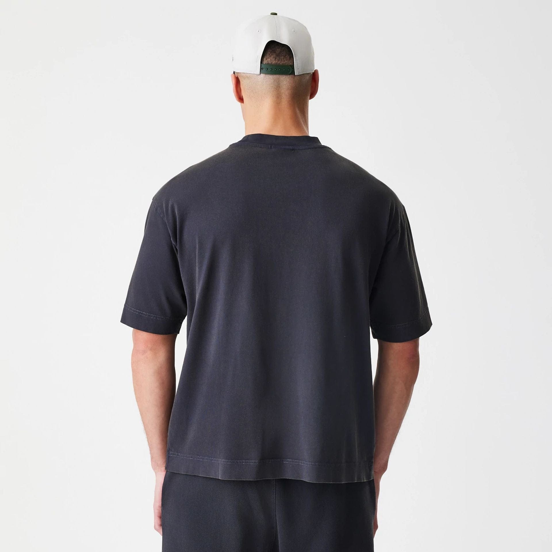 The Male model is wearing New Era Washed Black Oversized T-Shirt 2