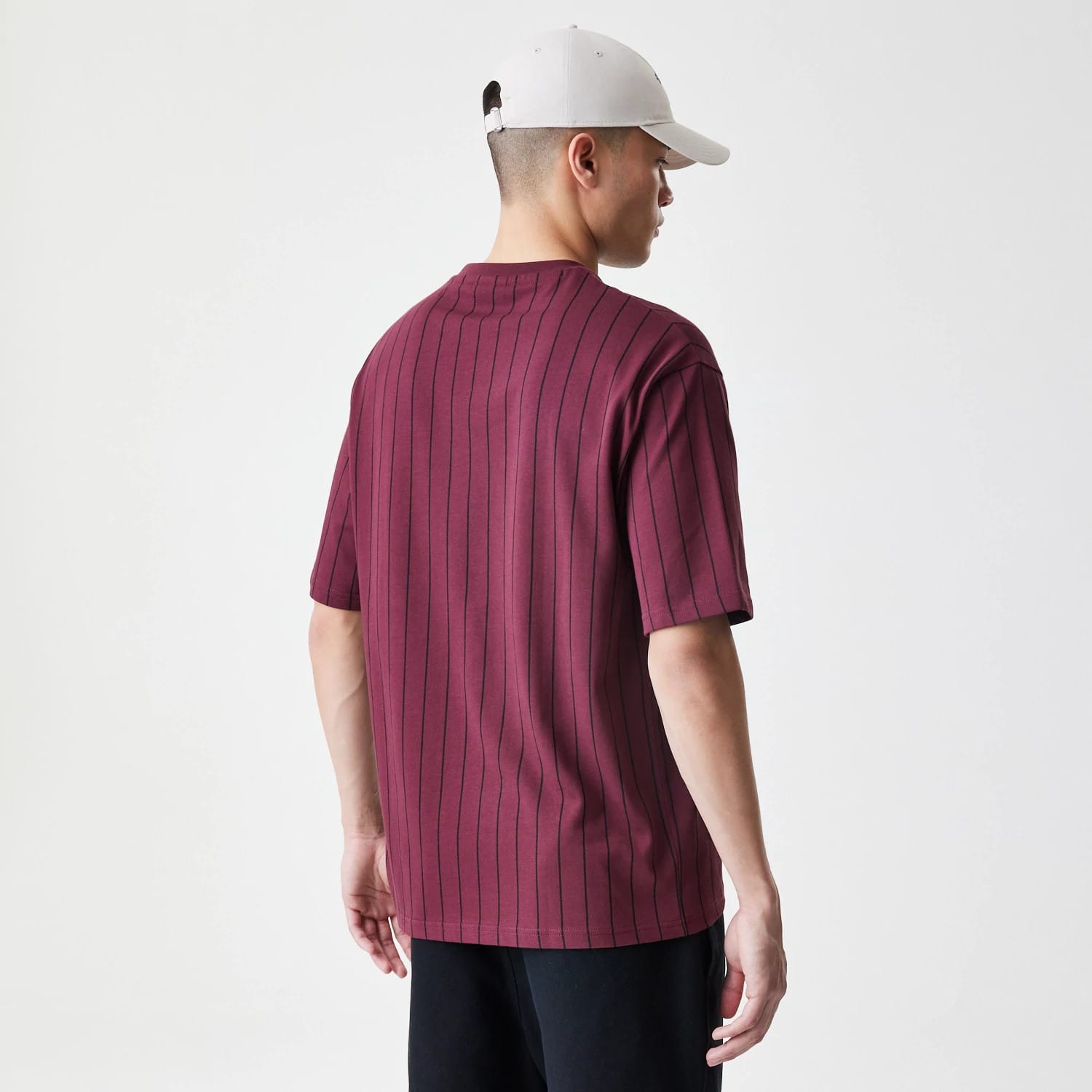 The Male model is wearing New Era Pinstripe Dark Red Oversized T-Shirt 2