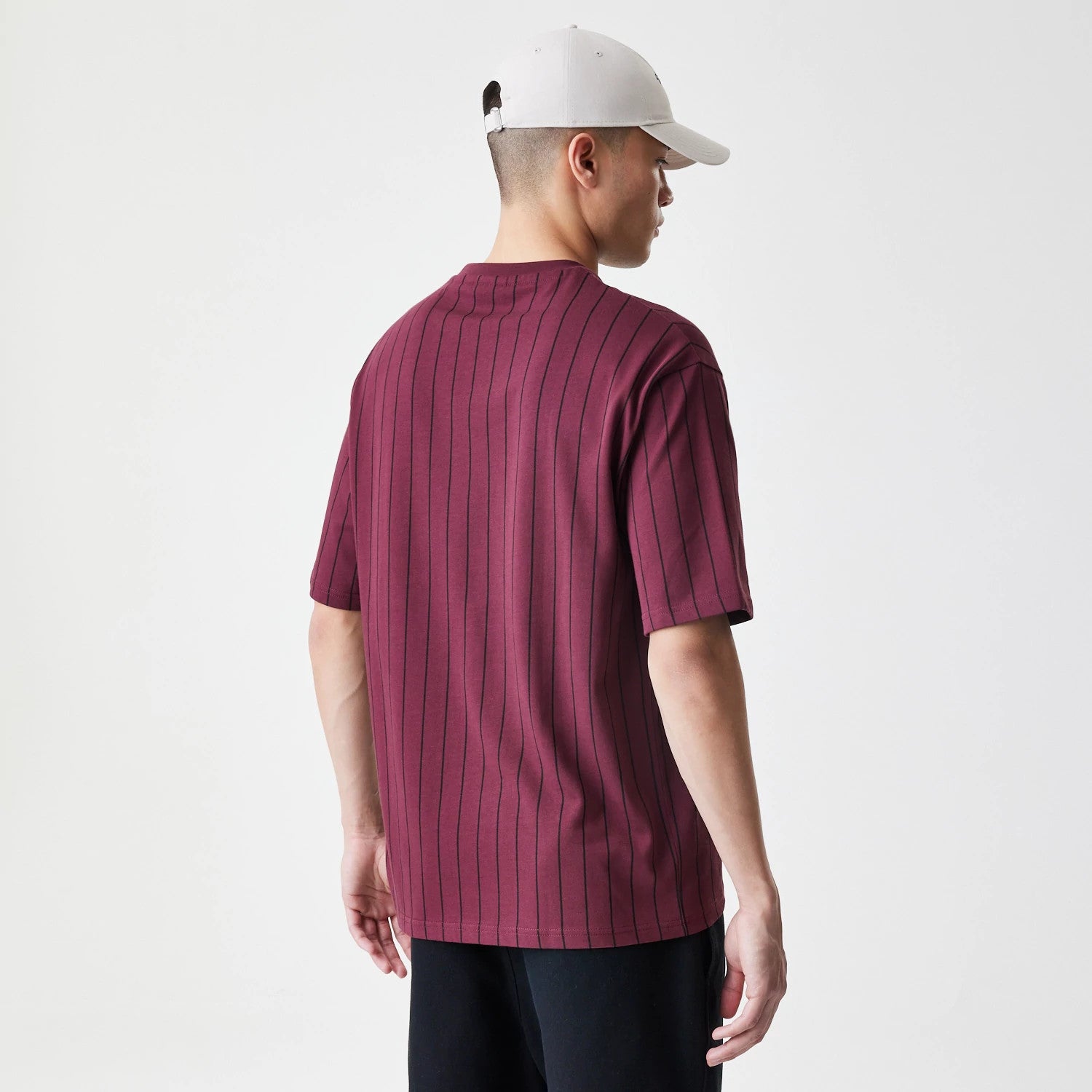 The Male model is wearing New Era Pinstripe Dark Red Oversized T-Shirt 2