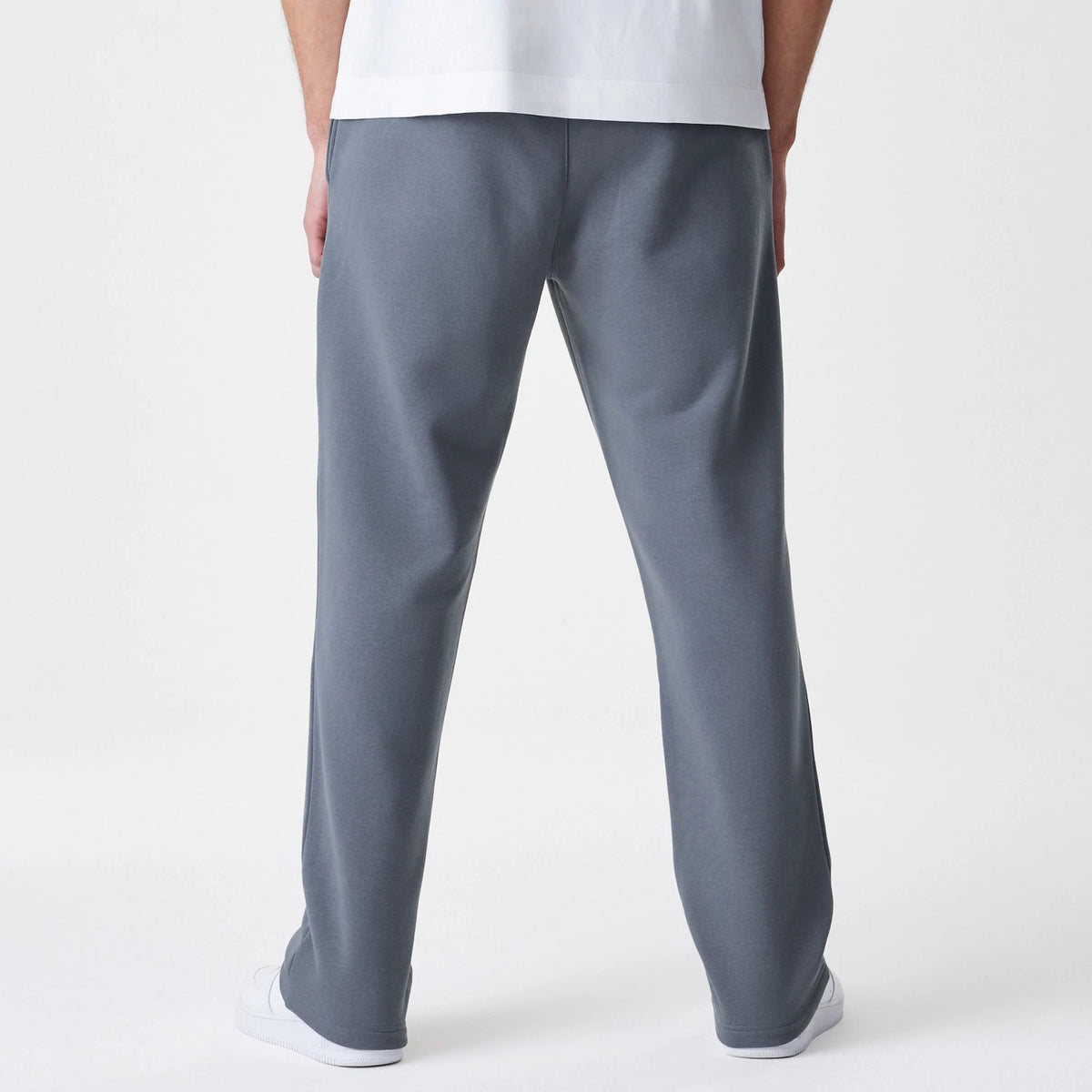 New Era LA Lakers NBA Linear Dark Grey Straight Leg Joggers, back view on a model showing the straight-leg fit and texture of the mid-grey fabric, worn casually with white trainers.