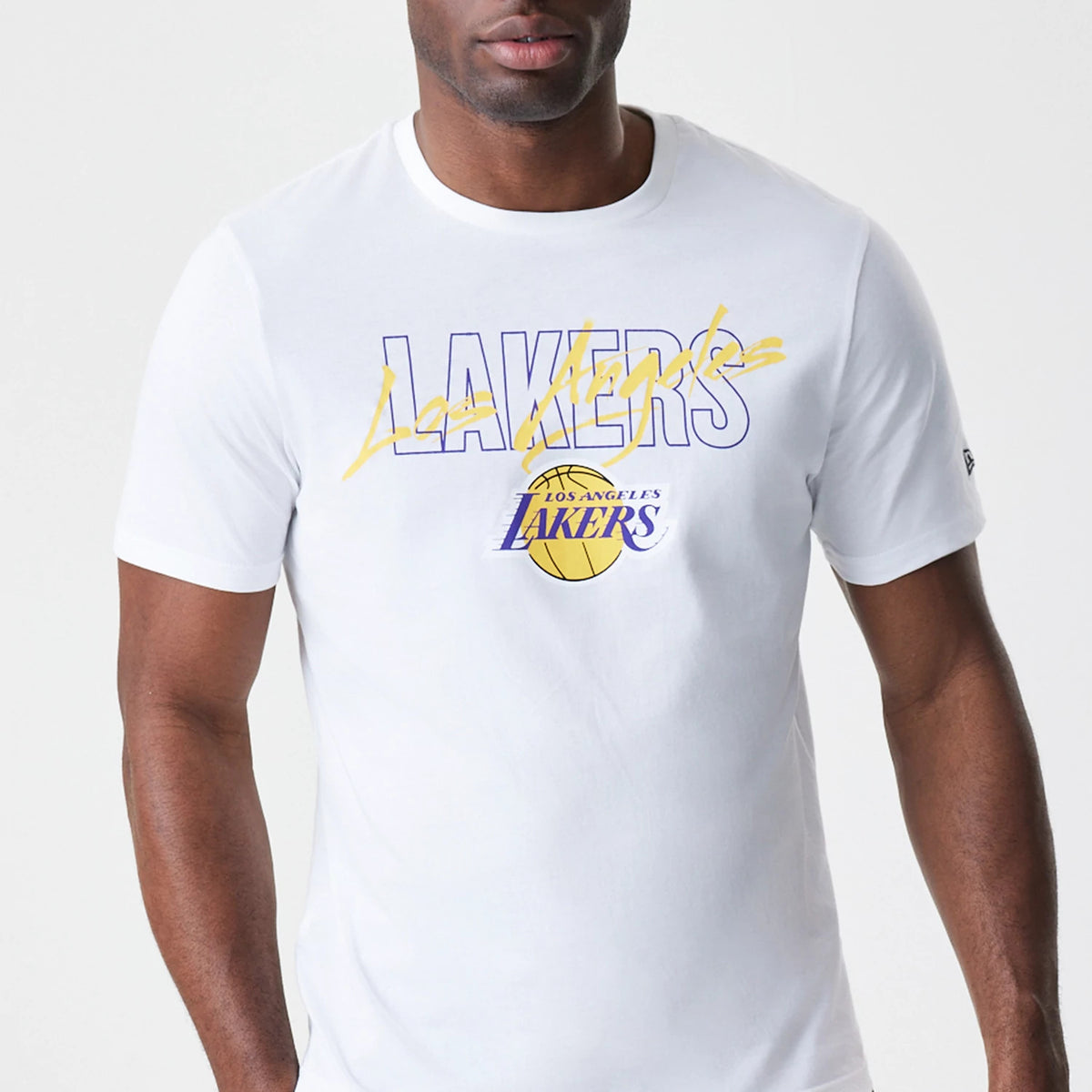 New Era LA Lakers NBA Script White T-Shirt, front view on-model showing the word Lakers in purple with yellow script across, and the Los Angeles Lakers logo with basketball underneath in the centre of the chest.