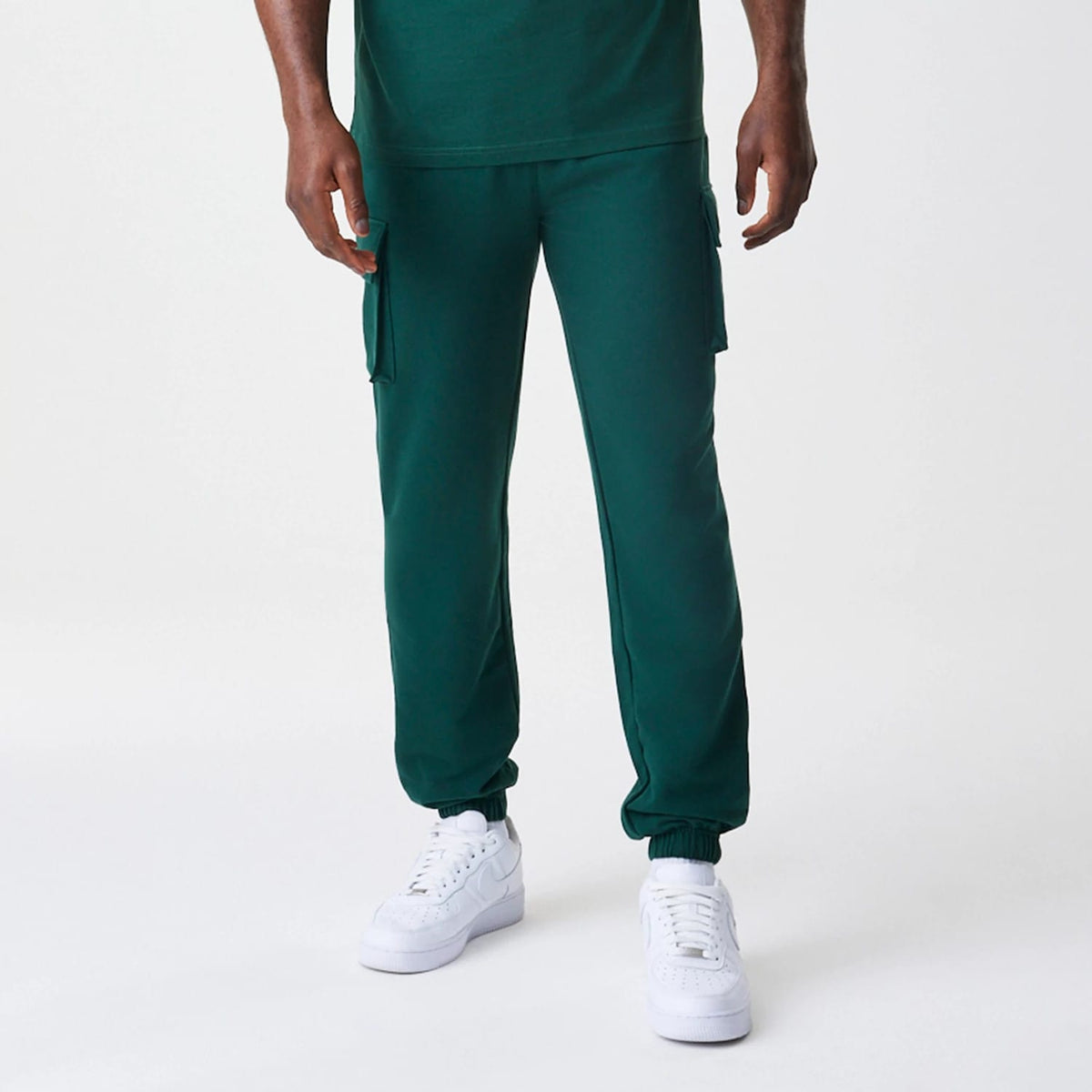 The Male model is wearing New Era Core Cargo Dark Green Joggers 3