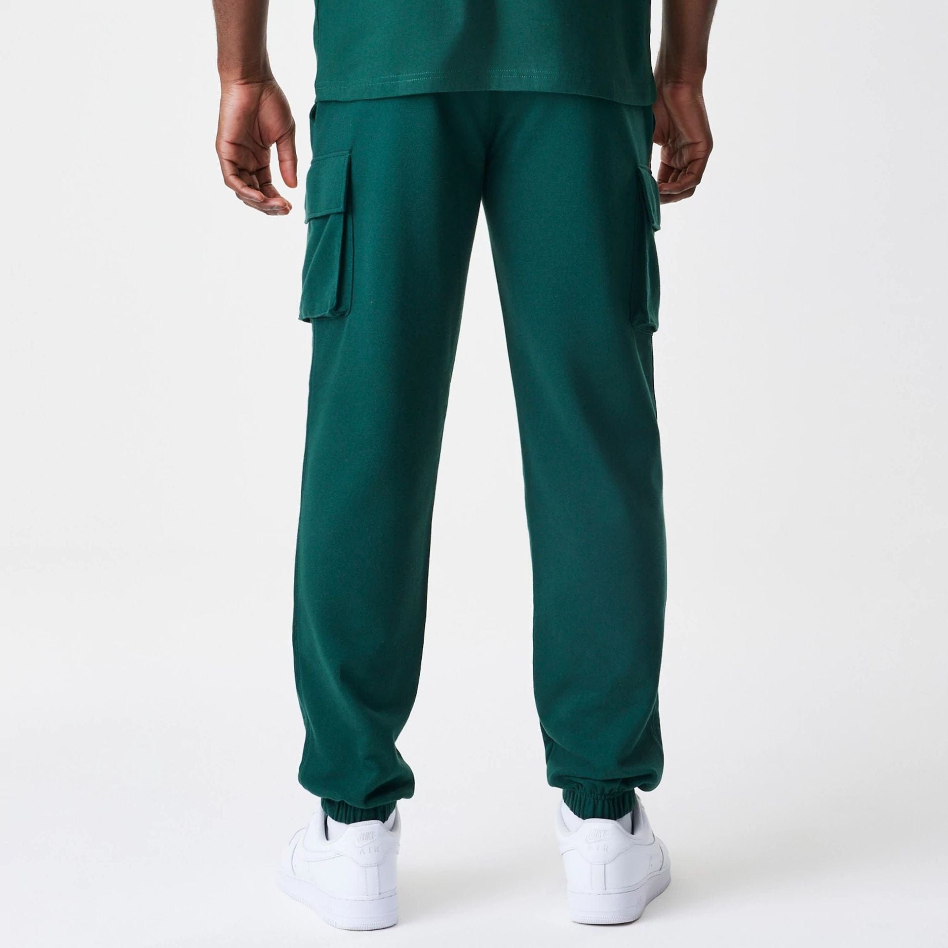 The Male model is wearing New Era Core Cargo Dark Green Joggers 2
