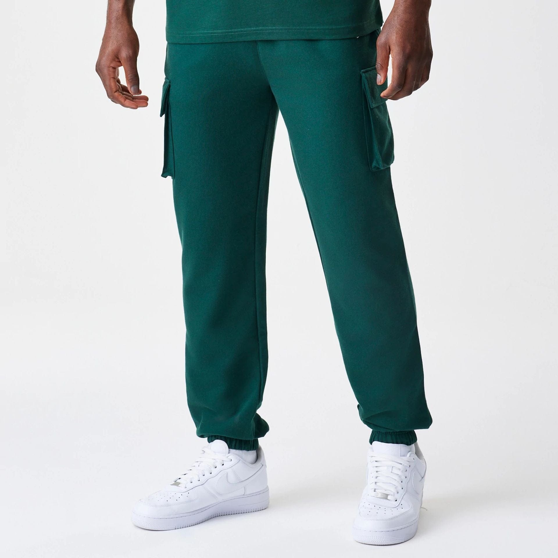 The Male model is wearing New Era Core Cargo Dark Green Joggers 1