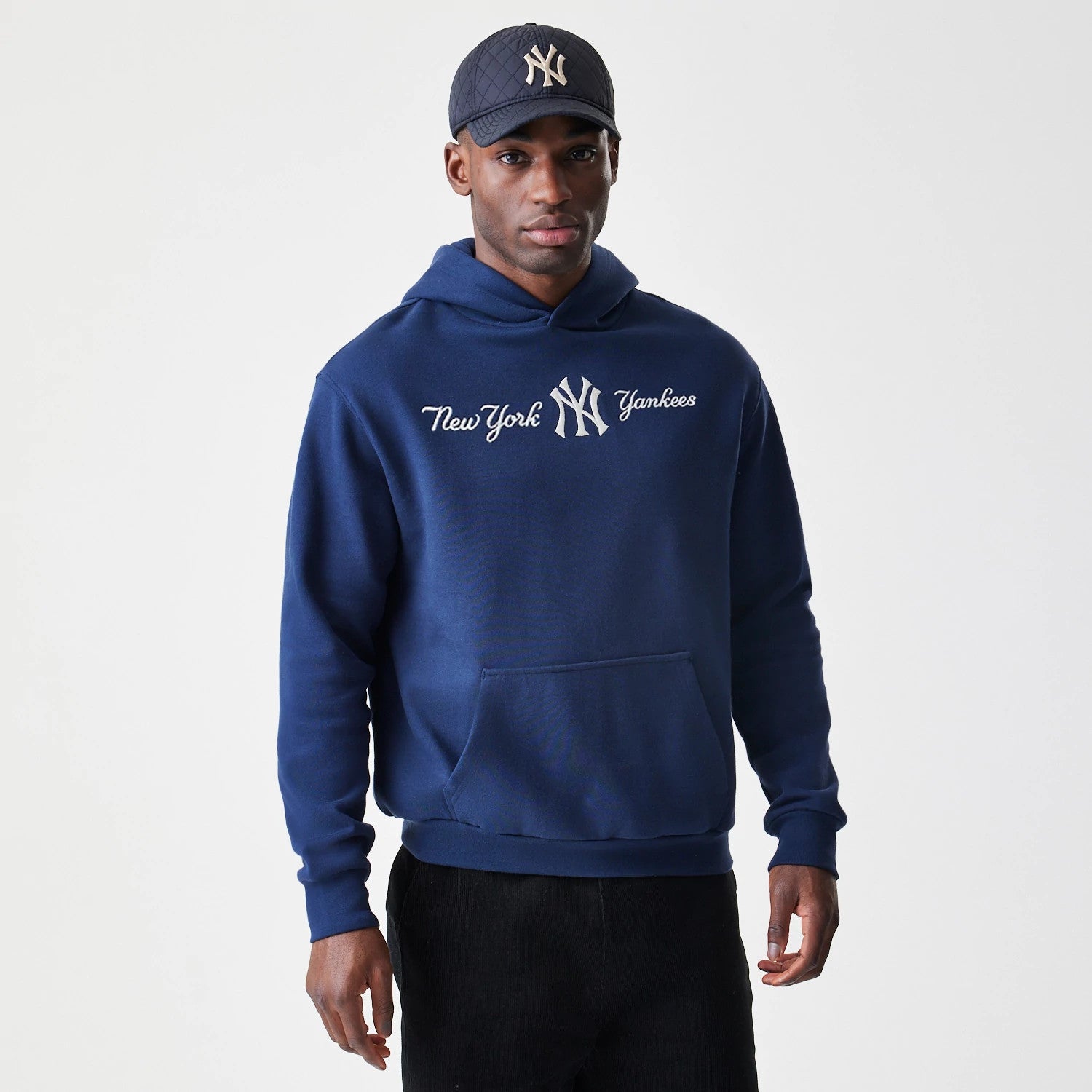 The Male model is wearing New York Yankees MLB Script Navy Oversized Pullover Hoodie 3