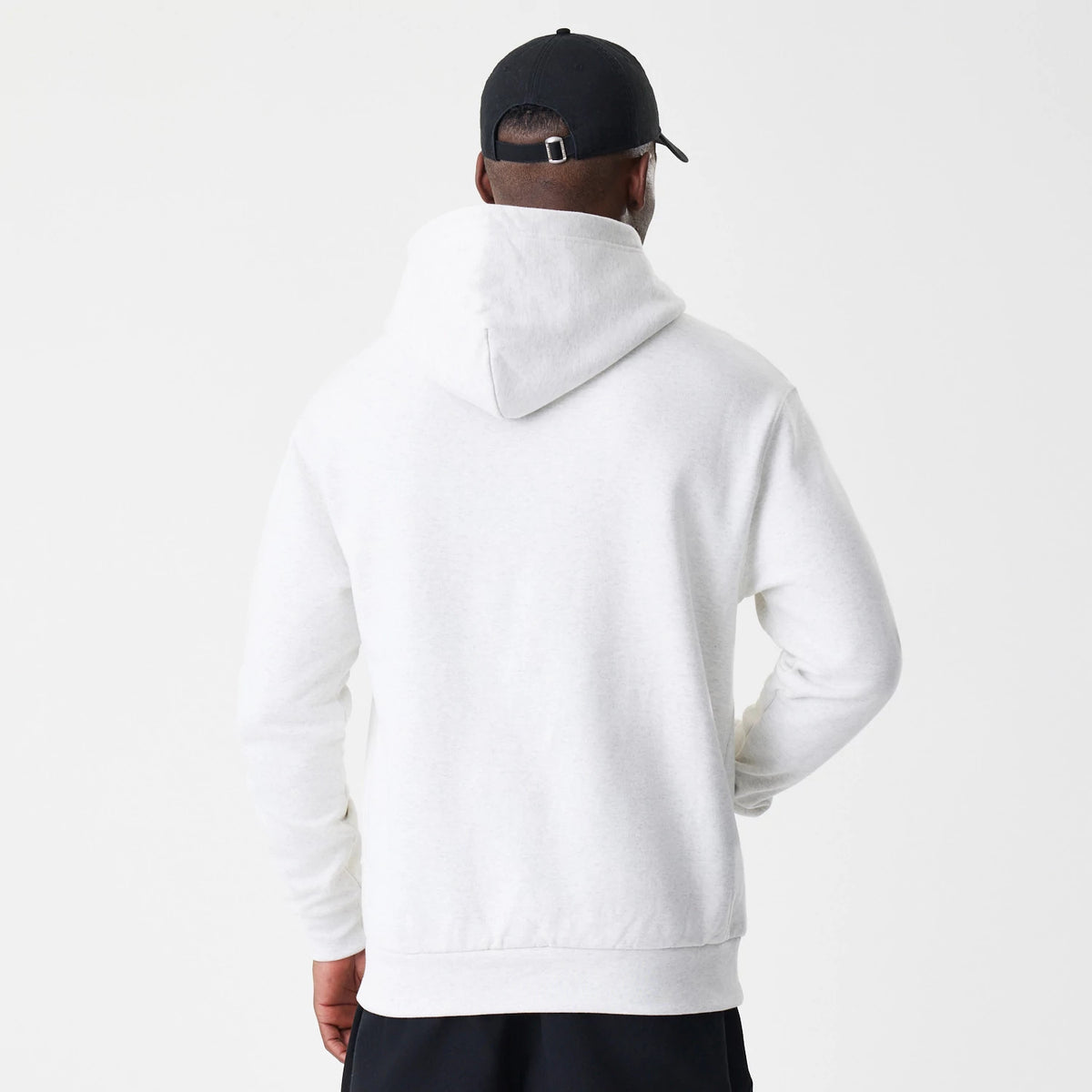 New Era LA Dodgers MLB Script White Oversized Pullover Hoodie, back view showing the plain white oversized hood and long sleeves on a relaxed fit, worn with a black cap, highlighting the simple, clean design.