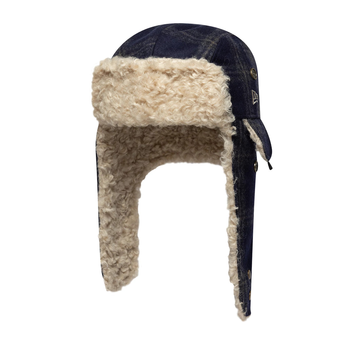 New Era Loden Navy Trapper Hat, side view showing the plush cream faux fur lining on the earflaps and front, with navy blue panels and brass button details, and a small New Era flag logo on the left side.