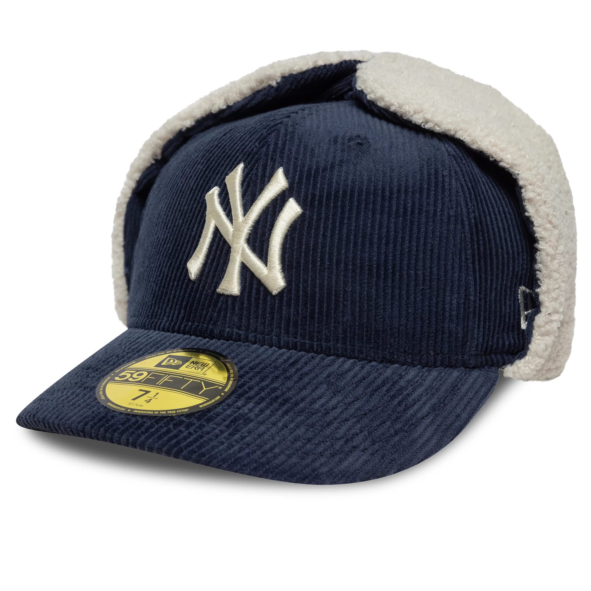 New York Yankees MLB Cord Navy Dogear New Era 59FIFTY Fitted Cap, three-quarter view showing the raised white embroidered NY logo on the front panel, gold 59FIFTY size sticker on the navy corduroy visor, and white fleece dogear flaps.