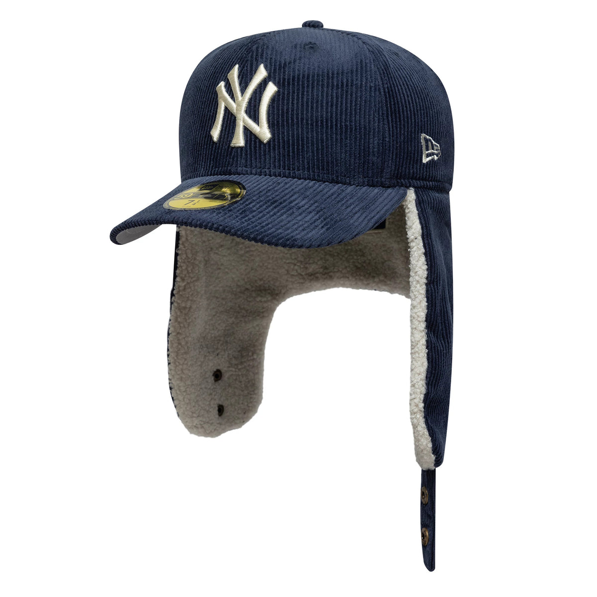 New York Yankees MLB Cord Navy Dogear New Era 59FIFTY Fitted Cap, three-quarter view showing the raised white NY embroidered logo on the structured navy cord crown, with earflaps lined in cream sherpa and a gold 59FIFTY size sticker on the visor.