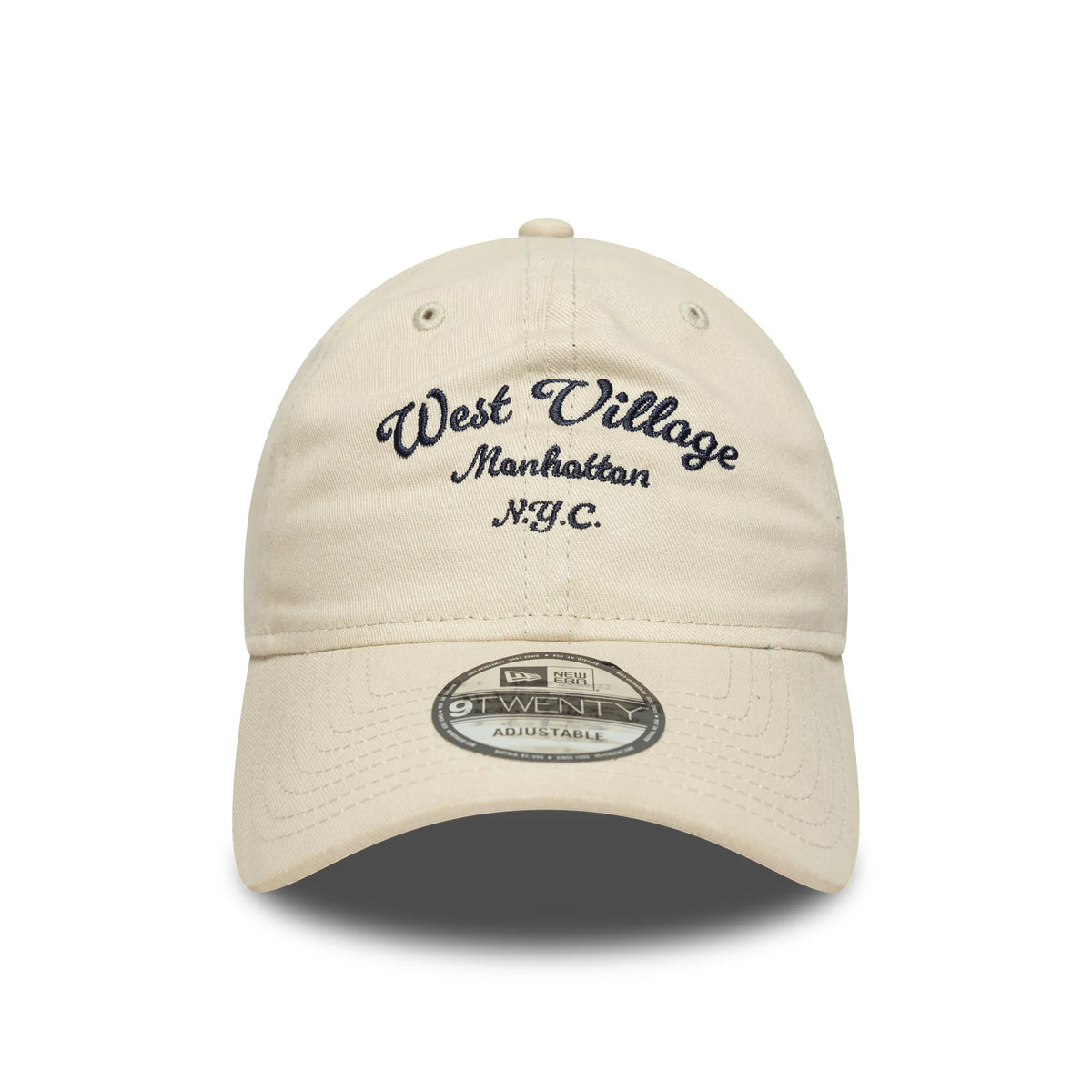 New Era Wordmark Cream New Era 9TWENTY Adjustable Cap, front view showing the navy West Village Manhattan N.Y.C. script embroidery on the front panel above the curved visor with a 9TWENTY size sticker.
