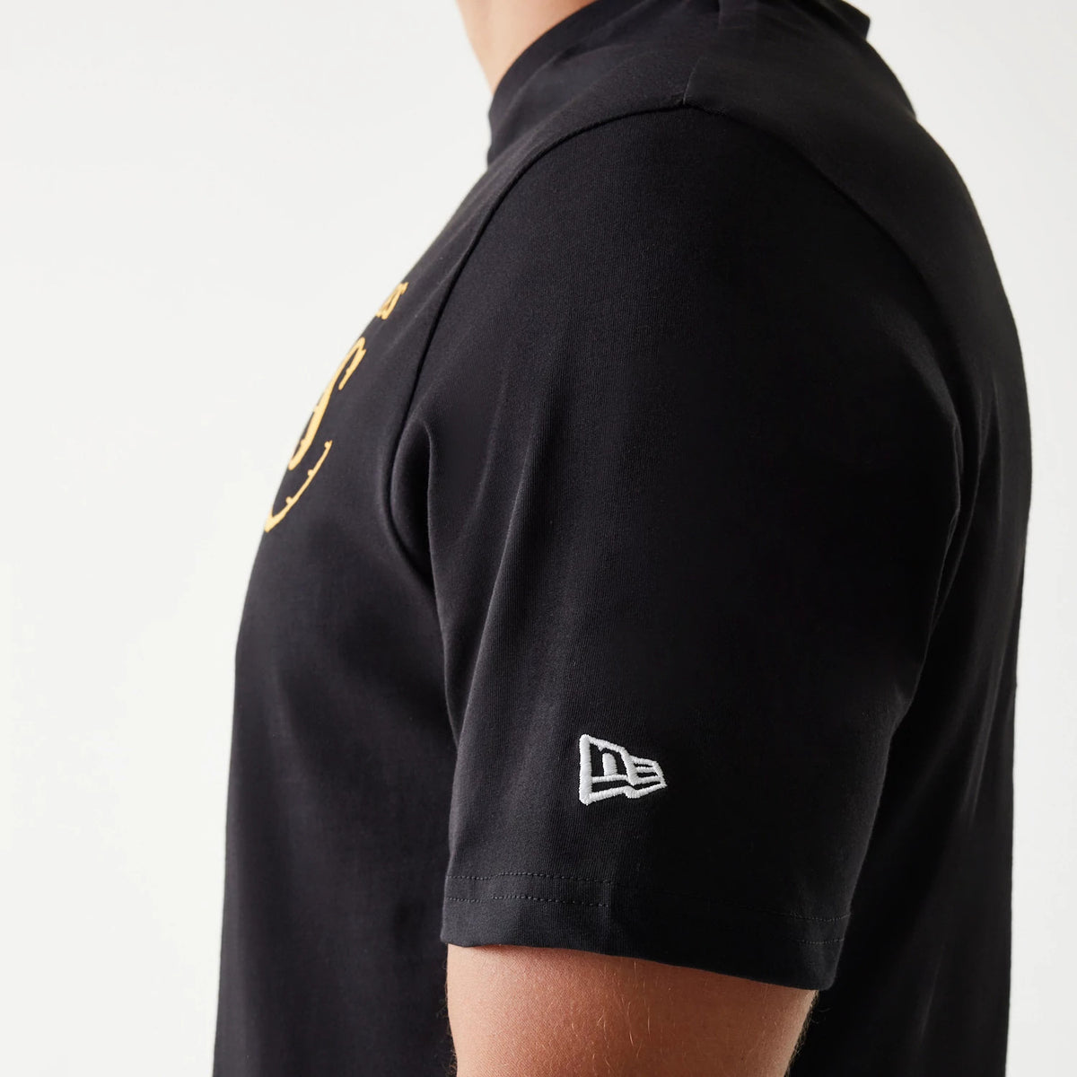 New Era LA Lakers NBA Flame Graphic Black T-Shirt, three-quarter view showing a black shirt with a white embroidered New Era logo on the left sleeve and a glimpse of a yellow flame graphic on the chest.