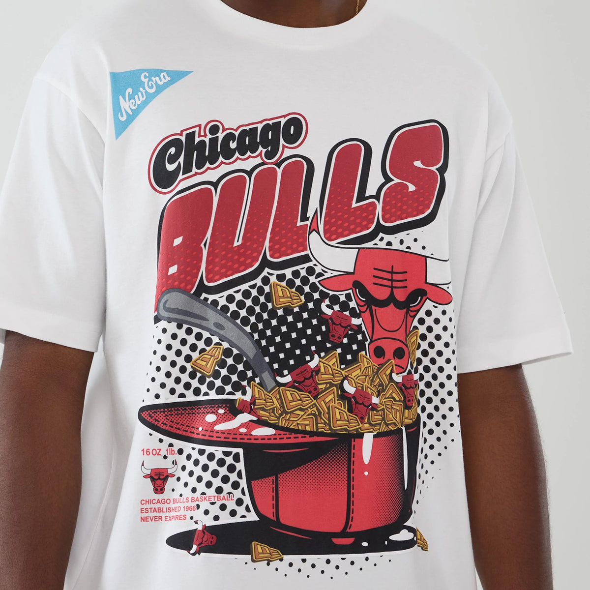 New Era Chicago Bulls NBA Lifestyle Graphic White T-Shirt, front view showing a graphic of the Bulls logo emerging from a popcorn pot, with large red and black Chicago Bulls lettering and checkered dot patterns across the white fabric.
