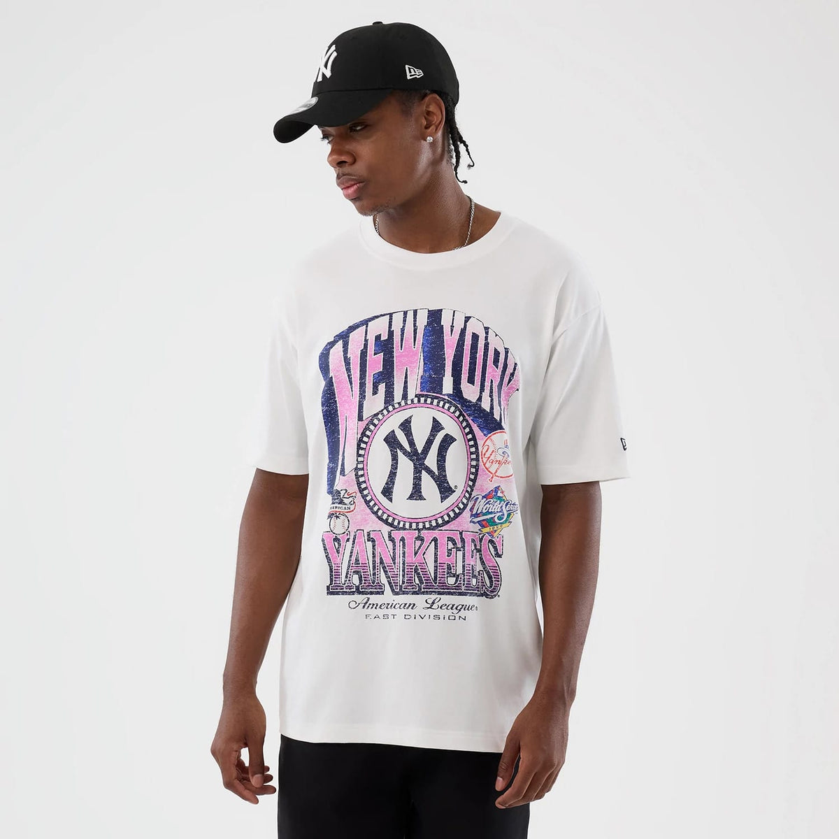 New Era New York Yankees Cooperstown MLB Sport Classic White T-Shirt, front view on-model displaying a large New York Yankees graphic with pink and blue accents across the chest, complemented by an embroidered New Era logo on the left sleeve.