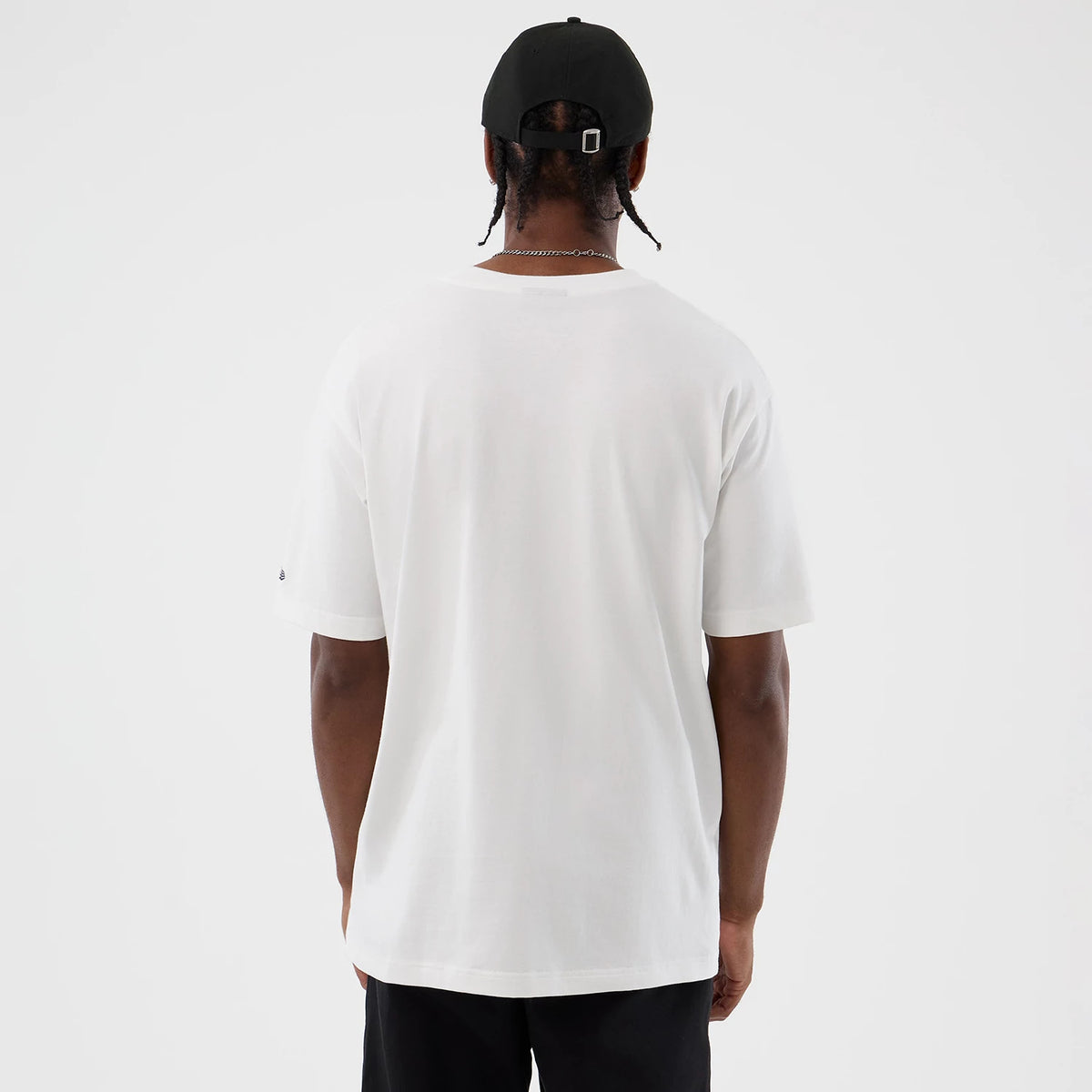 New Era New York Yankees Cooperstown MLB Sport Classic White T-Shirt, back view on a model, showing the plain white back with a small embroidered New Era logo on the sleeve and styled with a black cap.