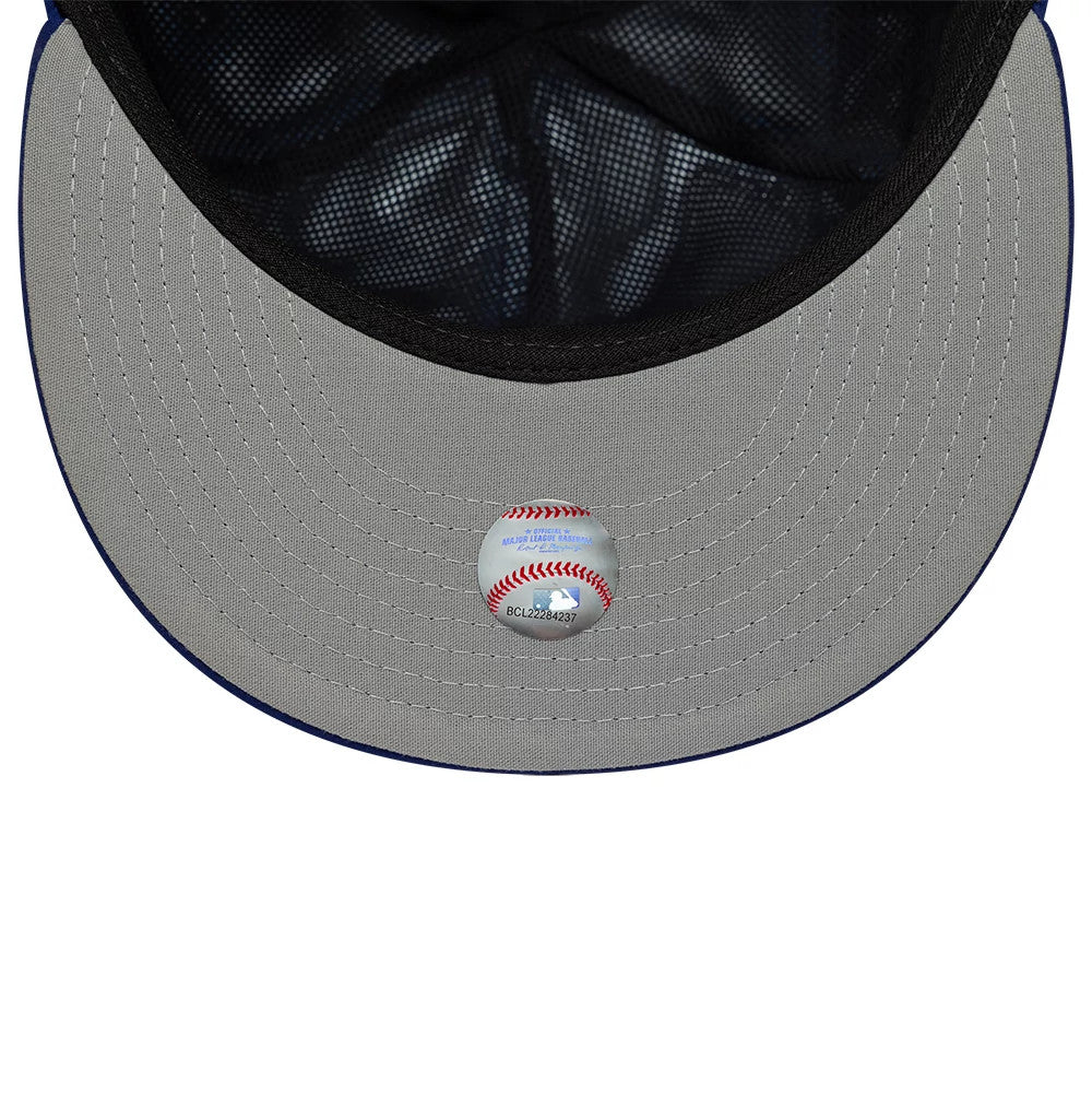 LA Dodgers MLB Gore-Tex Dark Blue New Era 59FIFTY Fitted Cap, inside view showing the grey undervisor with a baseball-themed sticker and dark interior taping under the structured blue crown.