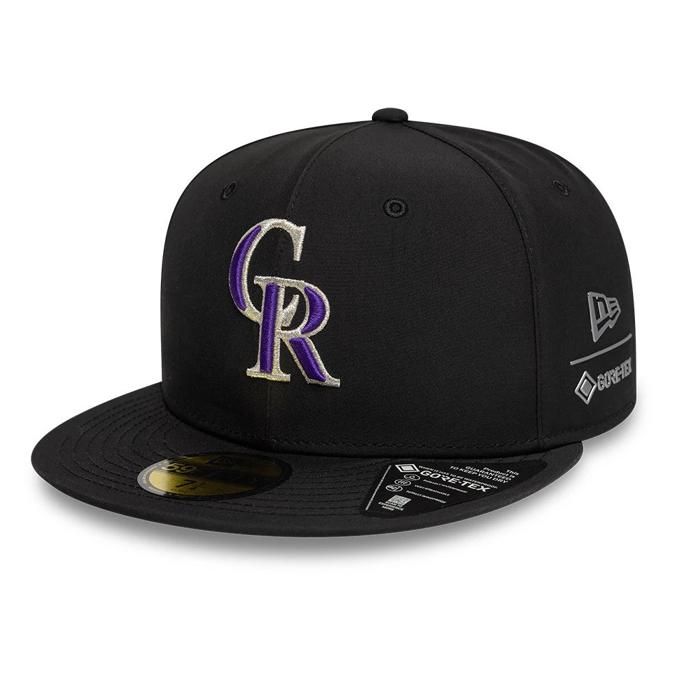Colorado Rockies MLB Gore-Tex Black New Era 59FIFTY Fitted Cap, three-quarter view showing purple and grey embroidered front logo, flat black visor with gold 59FIFTY size sticker, and Gore-Tex logo on the left side.