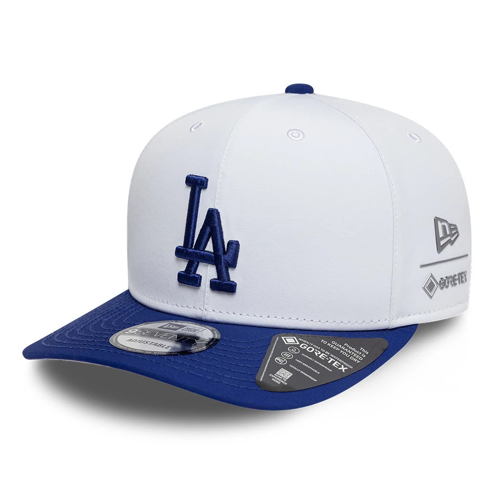 LA Dodgers MLB Gore-Tex White New Era 9SEVENTY Stretch Snap Adjustable Cap, front view showing the raised blue LA logo on the white crown, contrasted with a blue curved visor and New Era flag logo on the left side.