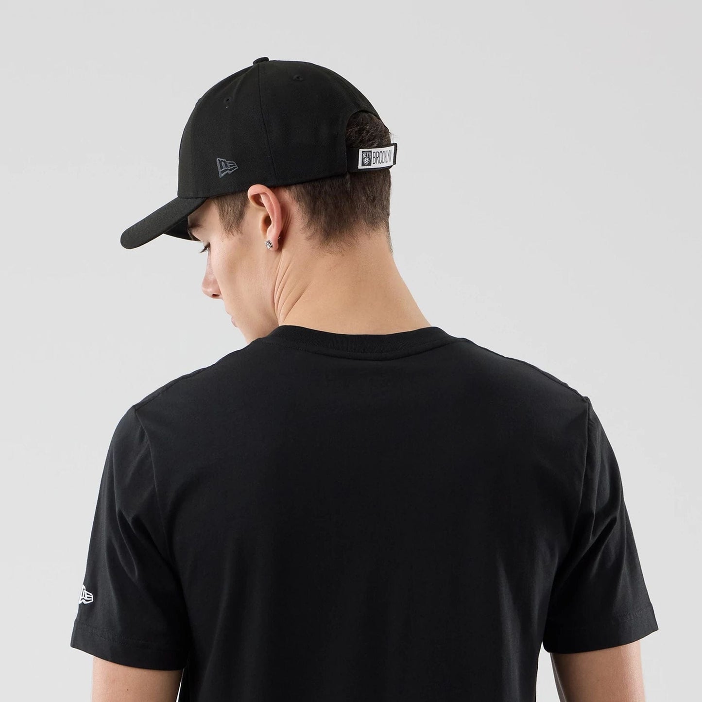 The Male model is wearing Brooklyn Nets NBA City Edition Black T-Shirt 7