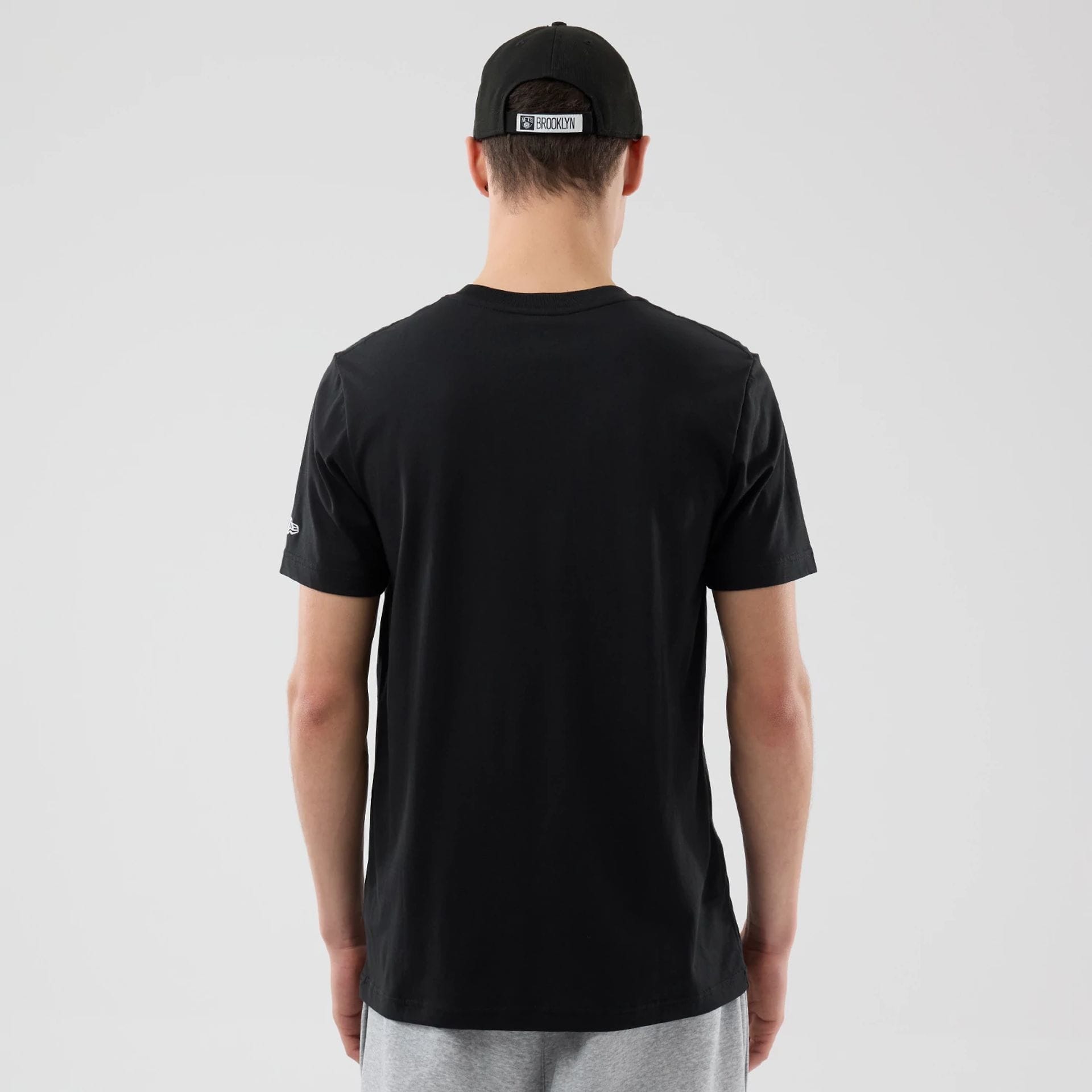 The Male model is wearing Brooklyn Nets NBA City Edition Black T-Shirt 2