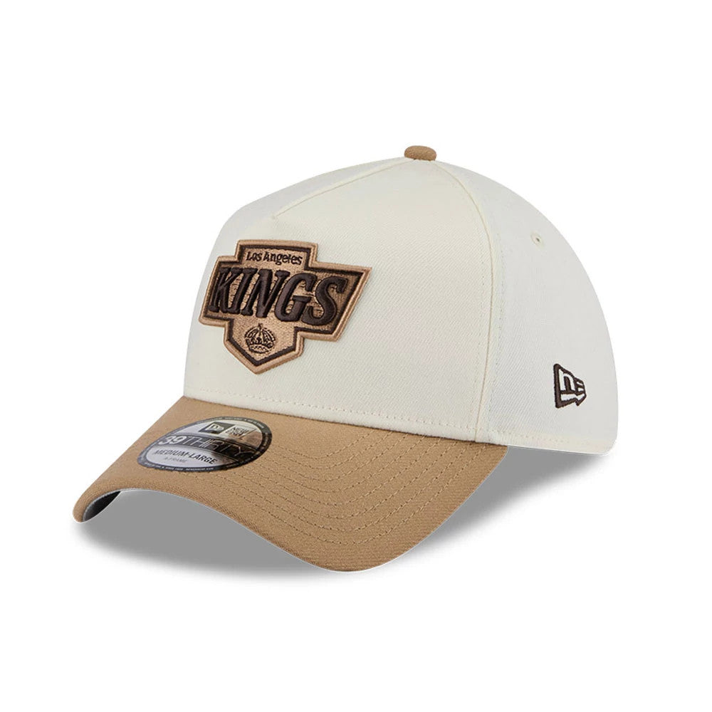 LA Kings NHL Sandy Bay White New Era 39THIRTY A-Frame Stretch Fit Cap, three-quarter view showing a brown raised embroidered Kings logo on the front panel, beige curved visor with a 39THIRTY size sticker and embroidered New Era flag on the left side.