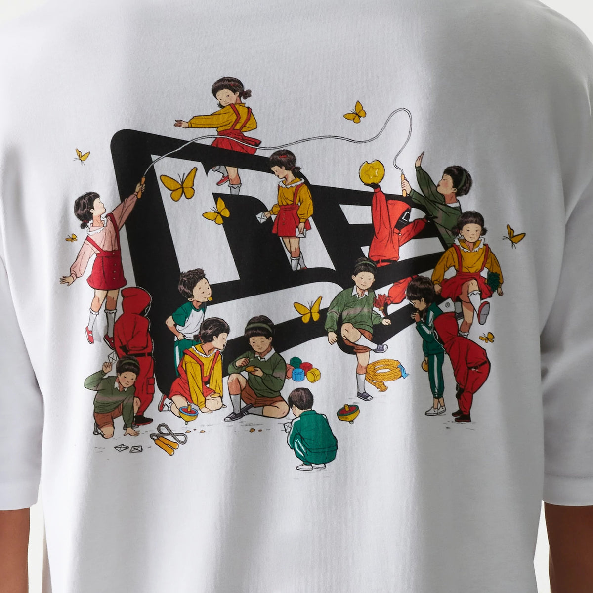 New Era Netflix Squid Game White Oversized T-Shirt, back view showing an illustration of children playing around a large printed New Era logo, with colours and scattered yellow butterflies adding detail.